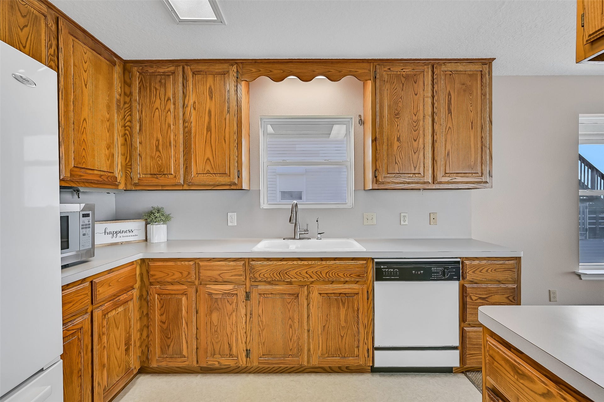 243 Isles End Road, #RR2, Tiki Island, TX 77554 Offering ample cabinet storage, neutral countertops, a recently updated faucet, and excellent workspace, the kitchen balances functionality with convenience. Its central location keeps you connected to both the living spaces and the spectacular waterfront views.