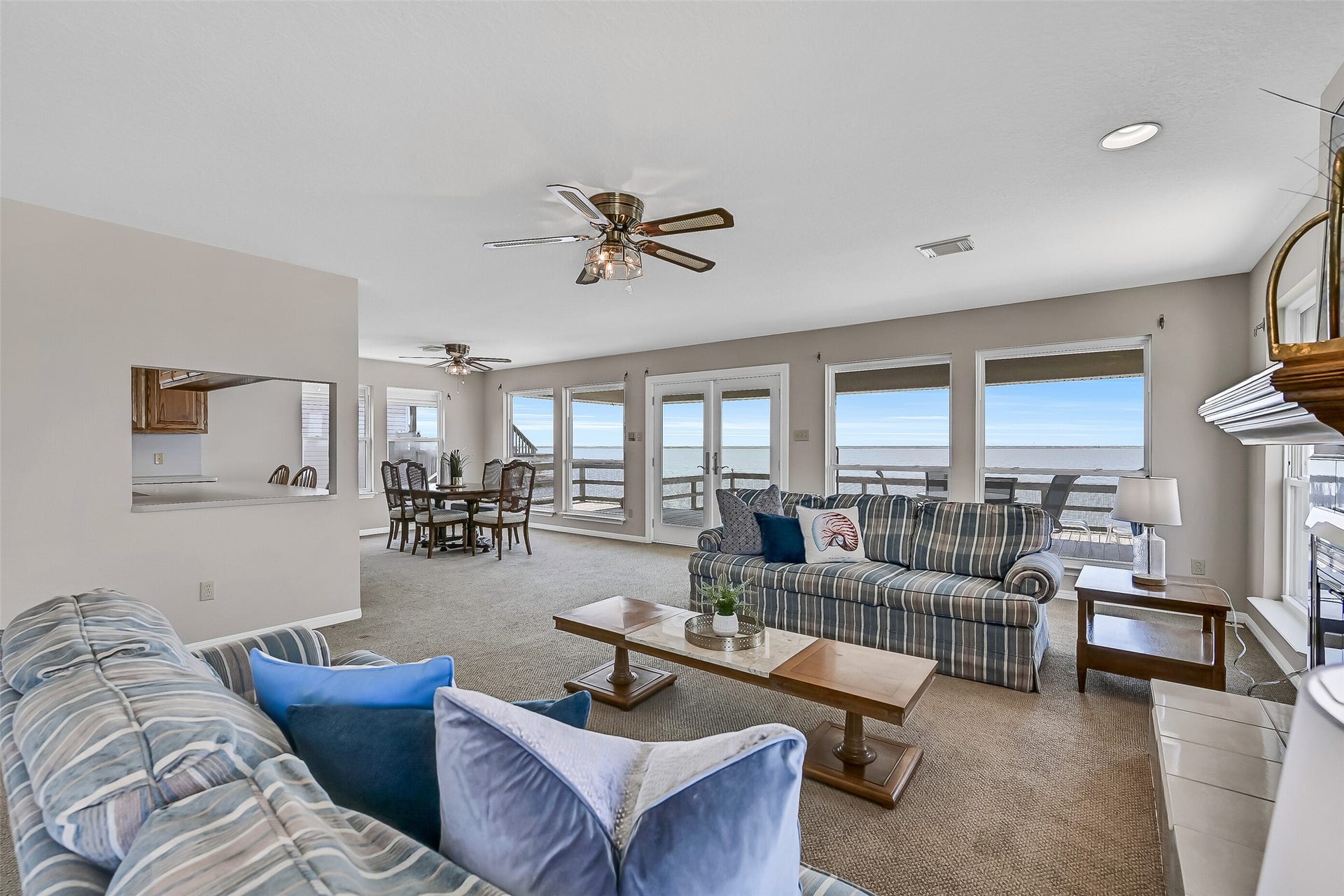 243 Isles End Road, #RR2, Tiki Island, TX 77554 Designed for entertaining, the open-concept layout flows effortlessly between the living and dining spaces while showcasing spectacular water views from nearly every angle. Large windows fill the room with natural light and capture the beauty of the bay beyond.