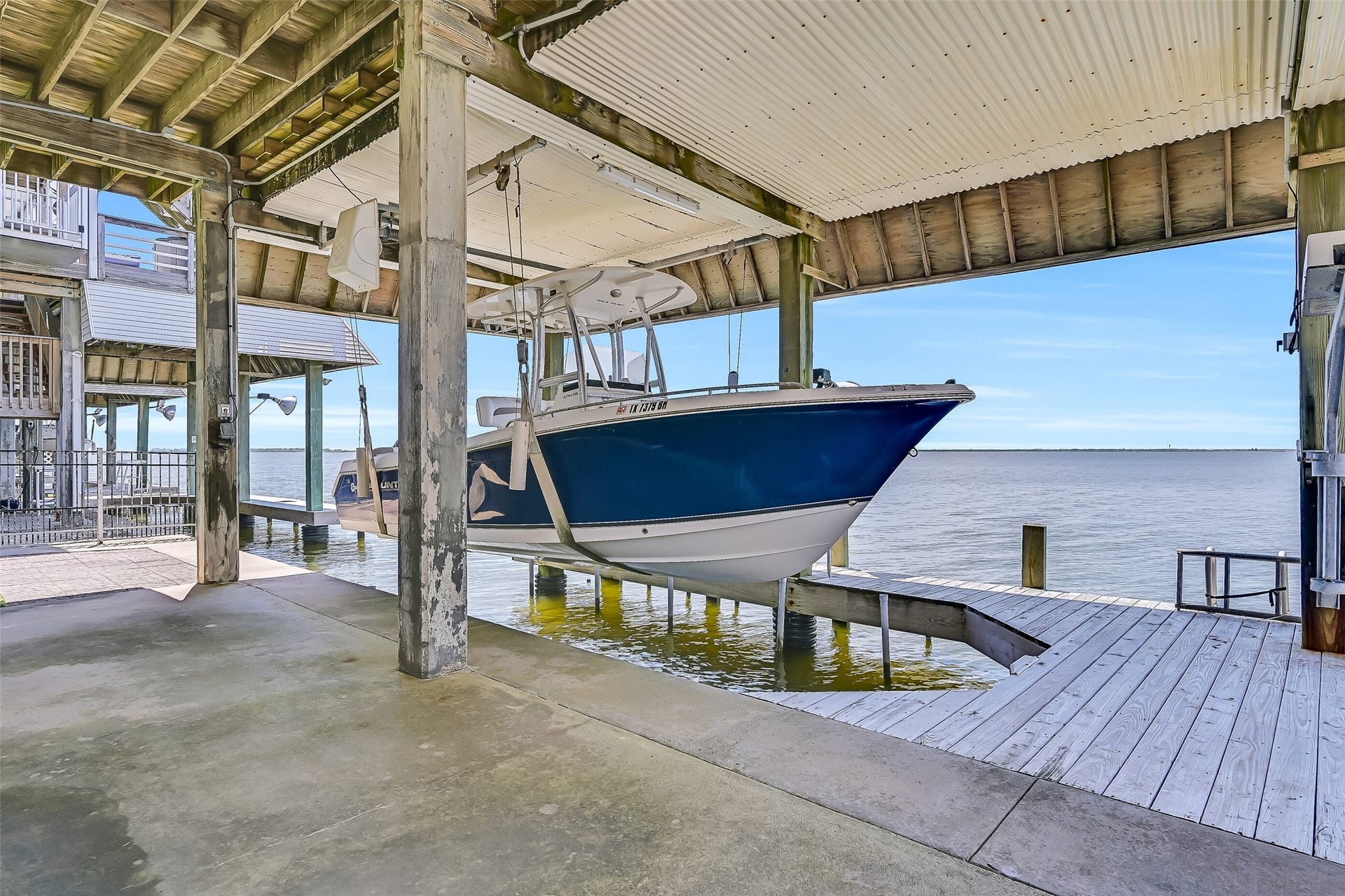 243 Isles End Road, #RR2, Tiki Island, TX 77554 Boating enthusiasts will appreciate the private covered boat lift and dock, offering convenient protected storage and immediate access to Jones Bay and West Bay beyond. Spend less time trailering and more time enjoying fishing, cruising, and exploring the Texas coast right from your own backyard.