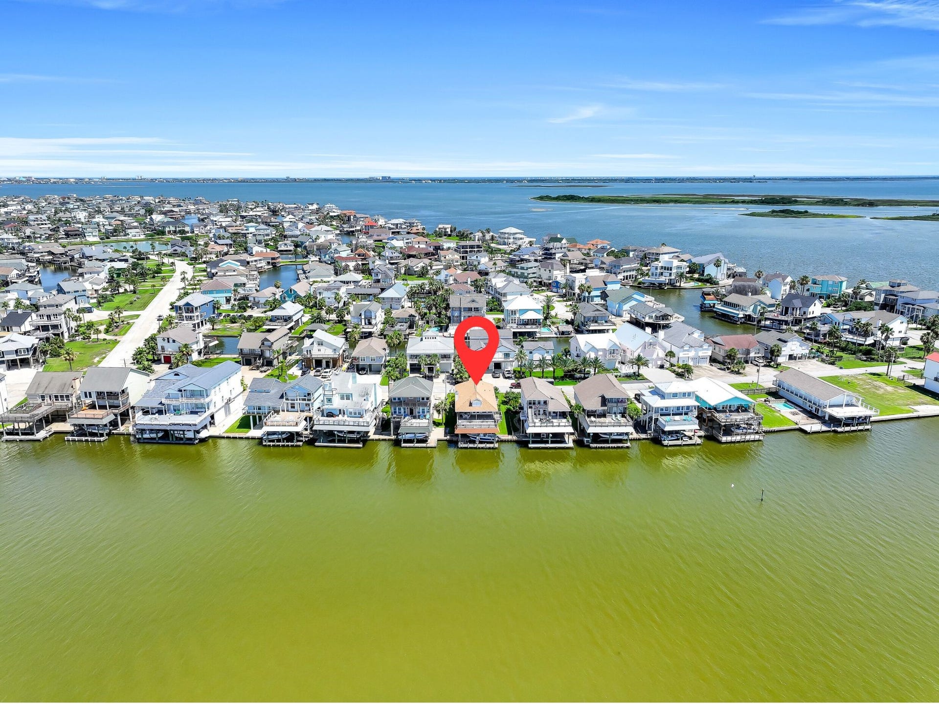 243 Isles End Road, #RR2, Tiki Island, TX 77554 This aerial perspective showcases the property's desirable waterfront location within one of the Gulf Coast's most sought-after boating communities. Enjoy the peaceful island atmosphere while remaining just minutes from Galveston beaches, restaurants, marinas, and convenient access back to the Houston area.