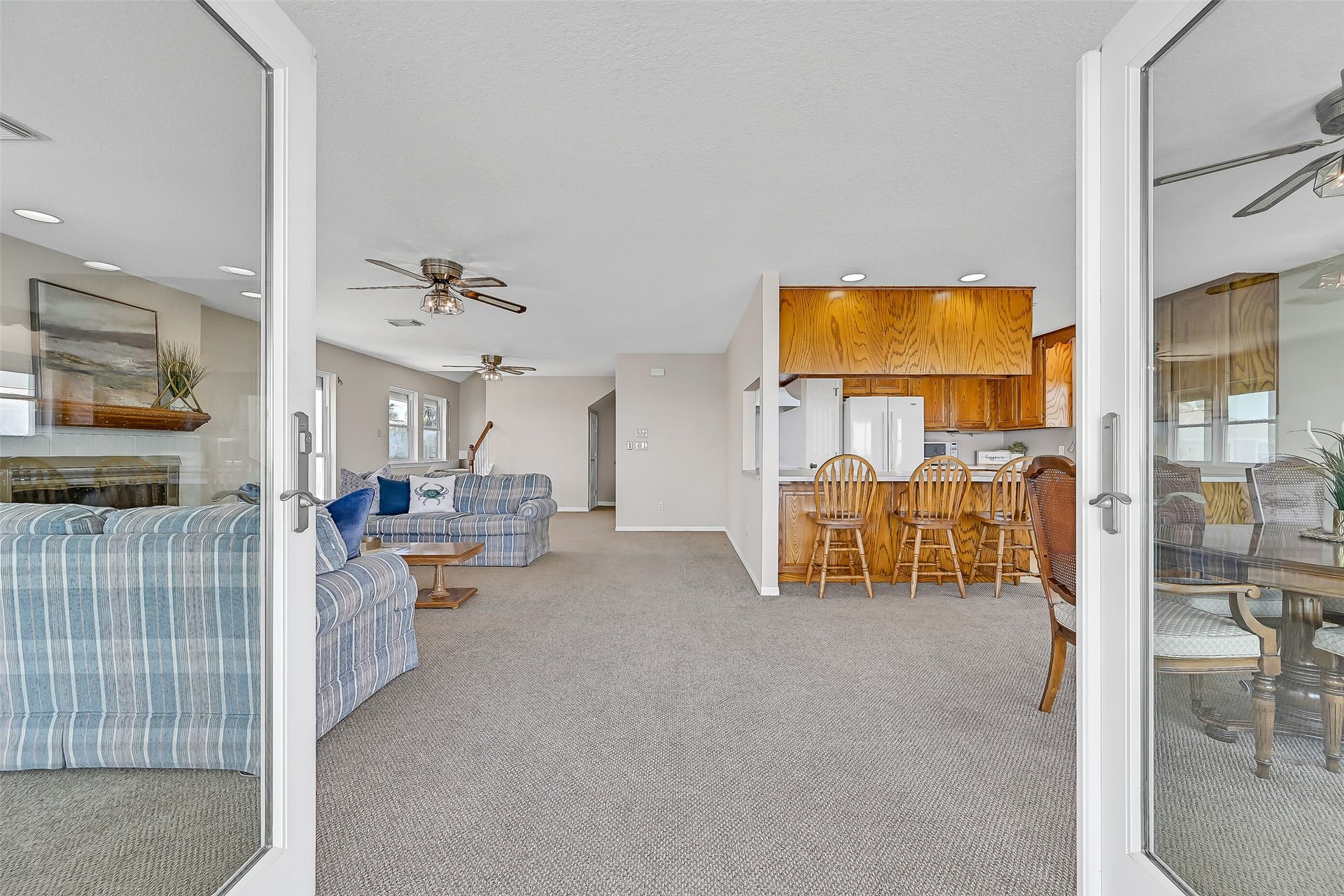 243 Isles End Road, #RR2, Tiki Island, TX 77554 Step through the second-floor entry and into an open-concept living, dining, and kitchen area designed to maximize the home's incredible waterfront setting. Fresh Sherwin-Williams Natural Linen paint and expansive gathering spaces create a comfortable backdrop for everyday coastal living.