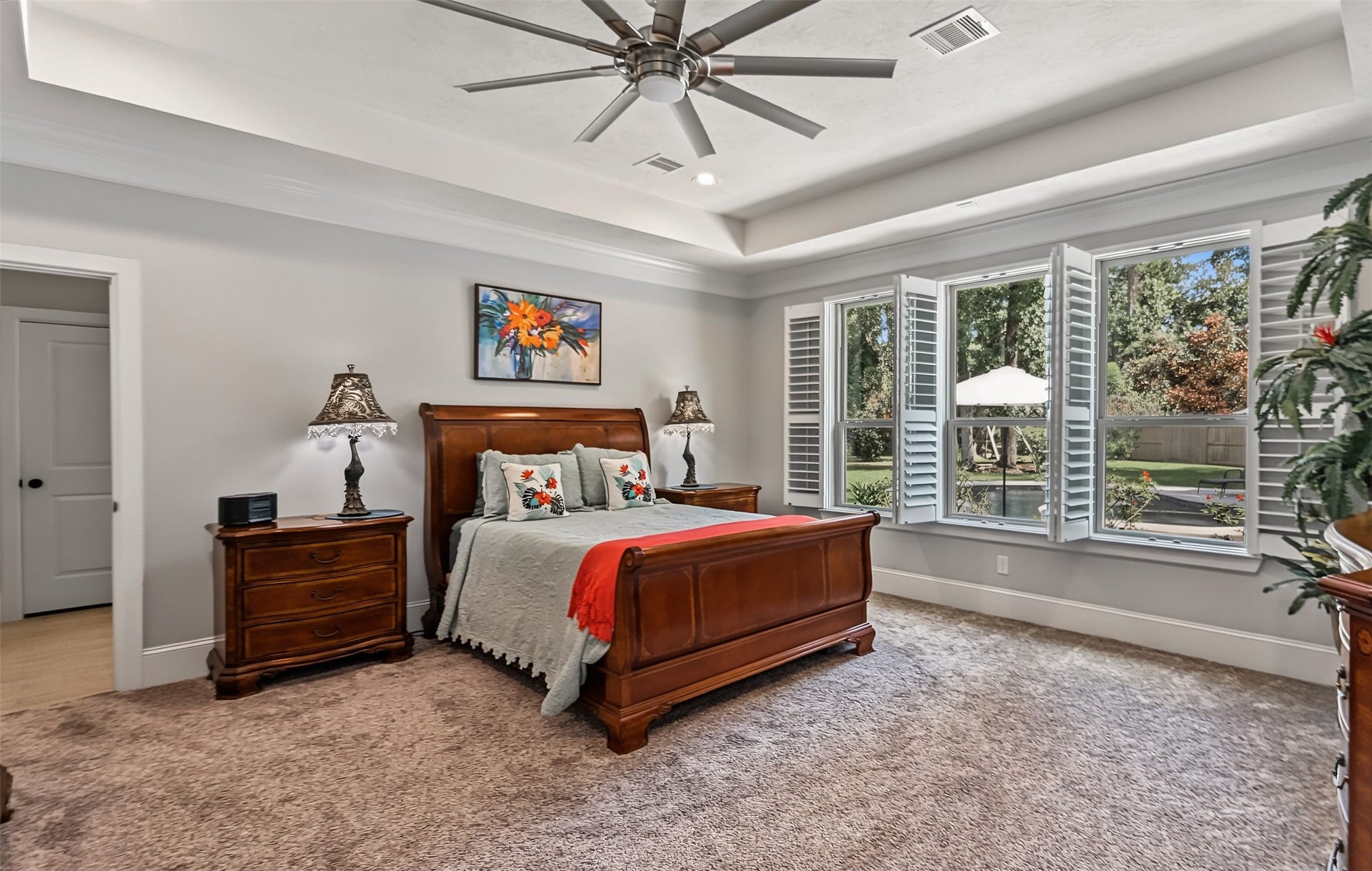 Spacious primary suite offering stunning views of a beautifully landscaped backyard.