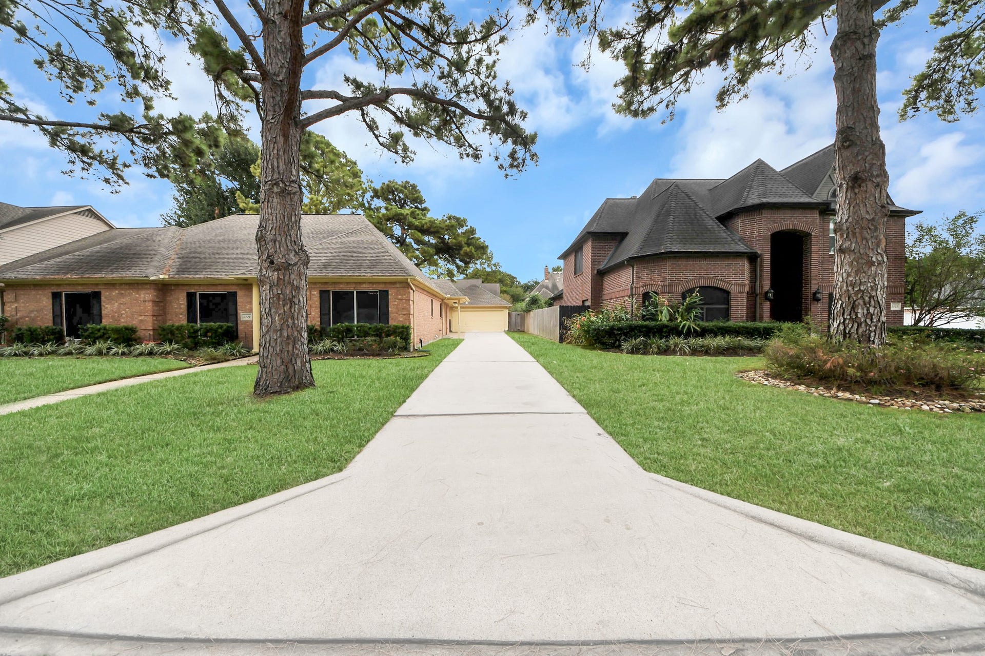 Manicured landscaping, a welcoming walkway.  It can accommodate multiple cars & trucks, and visitors without crowding the area near the house.