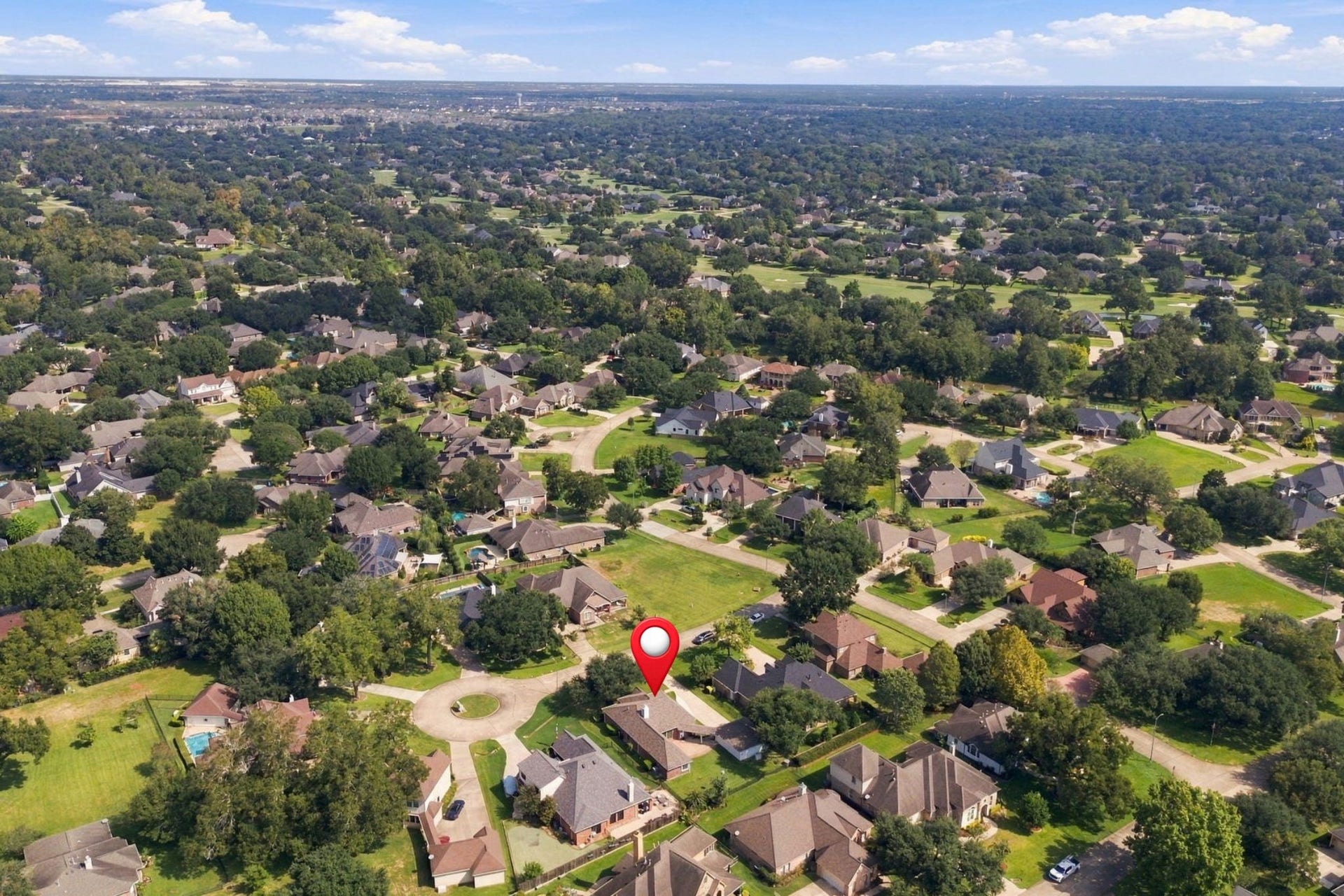 33211 Woodton Court, Weston Lakes, TX 77441 This aerial view looks northeast, showcasing the homes desirable Cul-De-Sac location. In the distance, you can catch a glimpse of the golf course, while the home is pinpointed for easy reference.