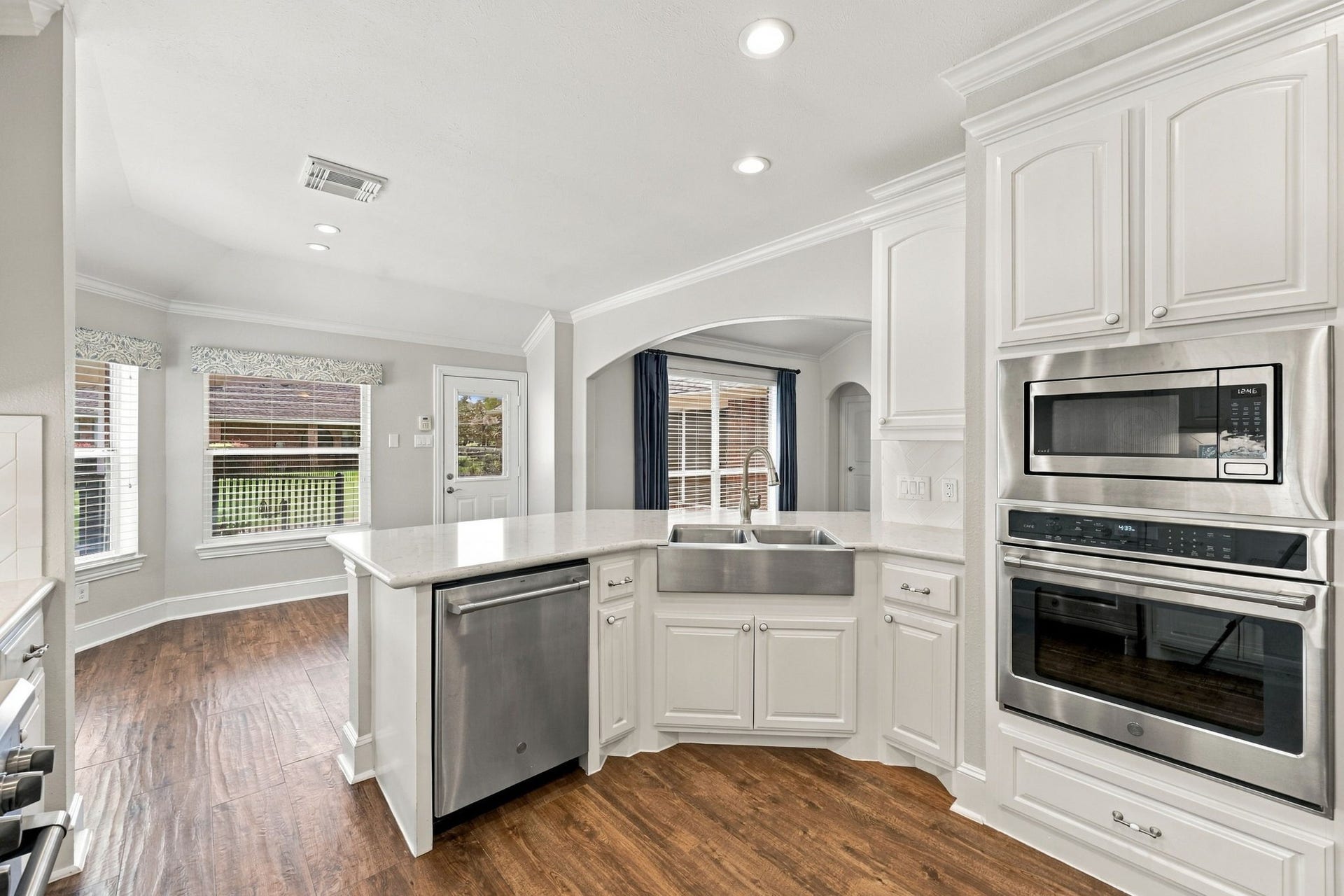 33211 Woodton Court, Weston Lakes, TX 77441 The second oven is a convenient convection electric oven with a microwave above, complemented by additional cabinetry that provides ample storage and keeps the space both functional and organized.