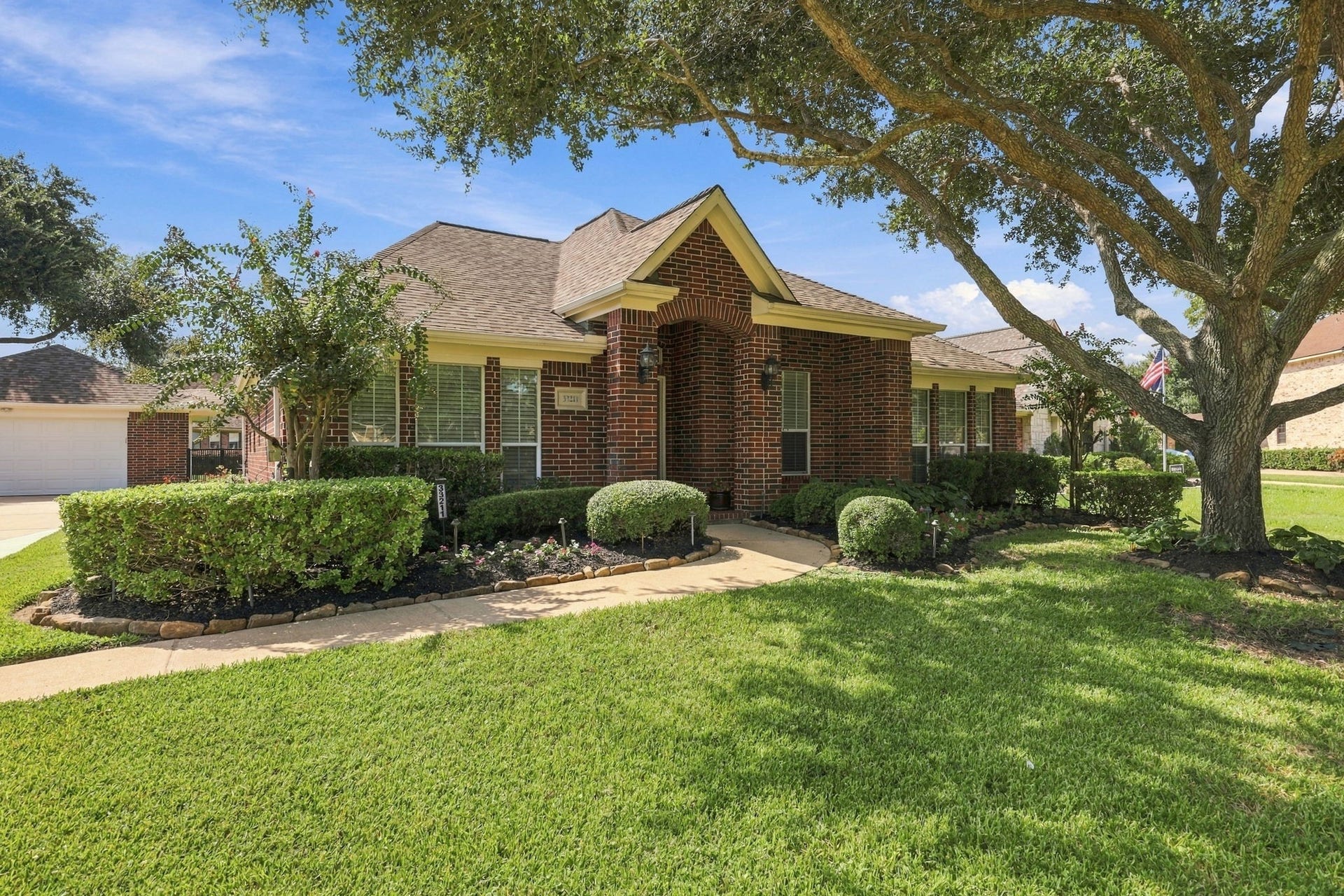 33211 Woodton Court, Weston Lakes, TX 77441 A charming sidewalk leads to the inviting covered Front Porch, creating a welcoming entryway and the perfect spot to enjoy the beautifully landscaped surroundings.