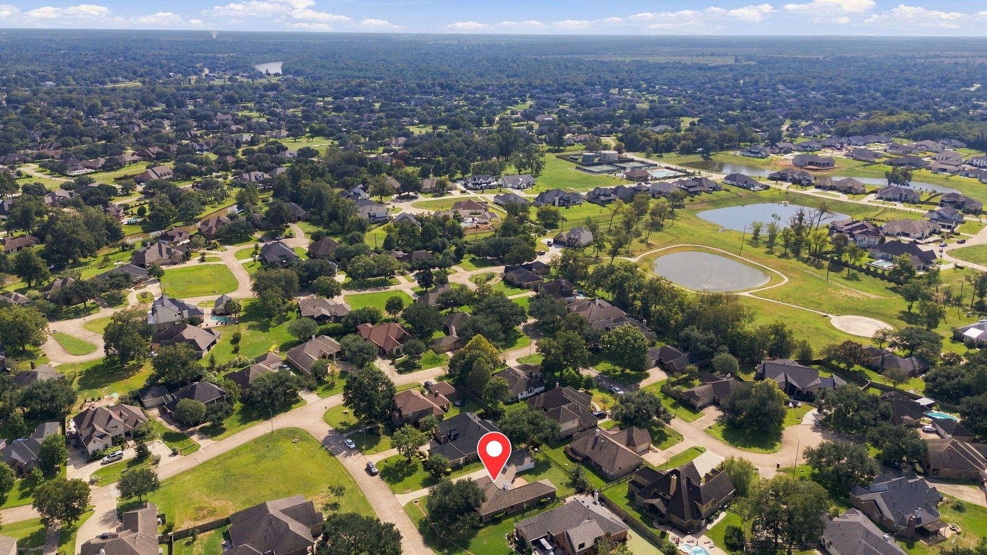 33211 Woodton Court, Weston Lakes, TX 77441 This aerial view is looking south and showcases the surrounding area, with the home pinpointed for easy reference and a clear perspective of its desirable location within Weston Lakes.