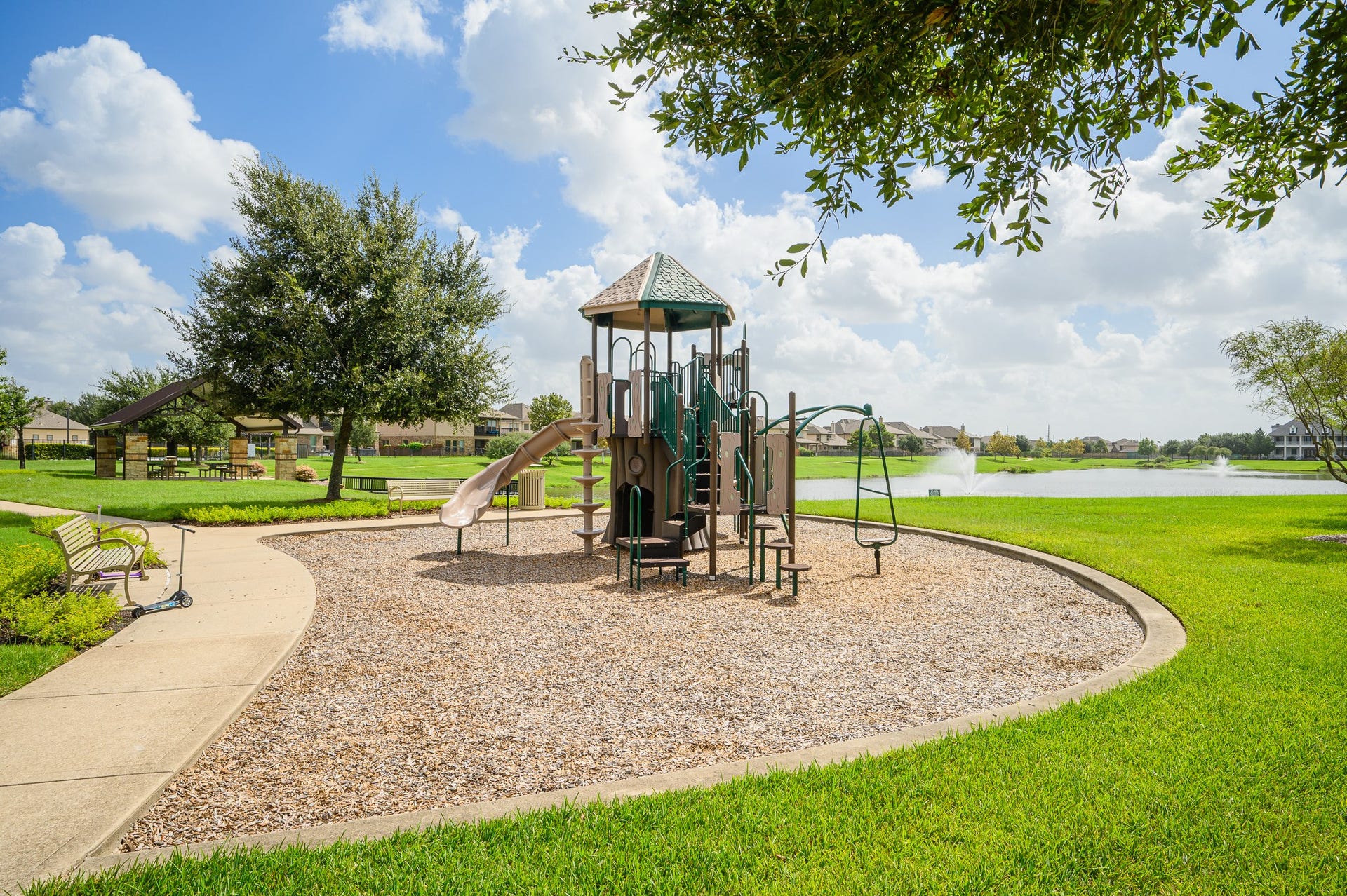 25610 Buckley Bluff Lane, Katy, TX 77494 Nestled in a charming neighborhood, this inviting playground features modern equipment, lush greenery, and a scenic pond view, creating the perfect setting for family fun and relaxation.