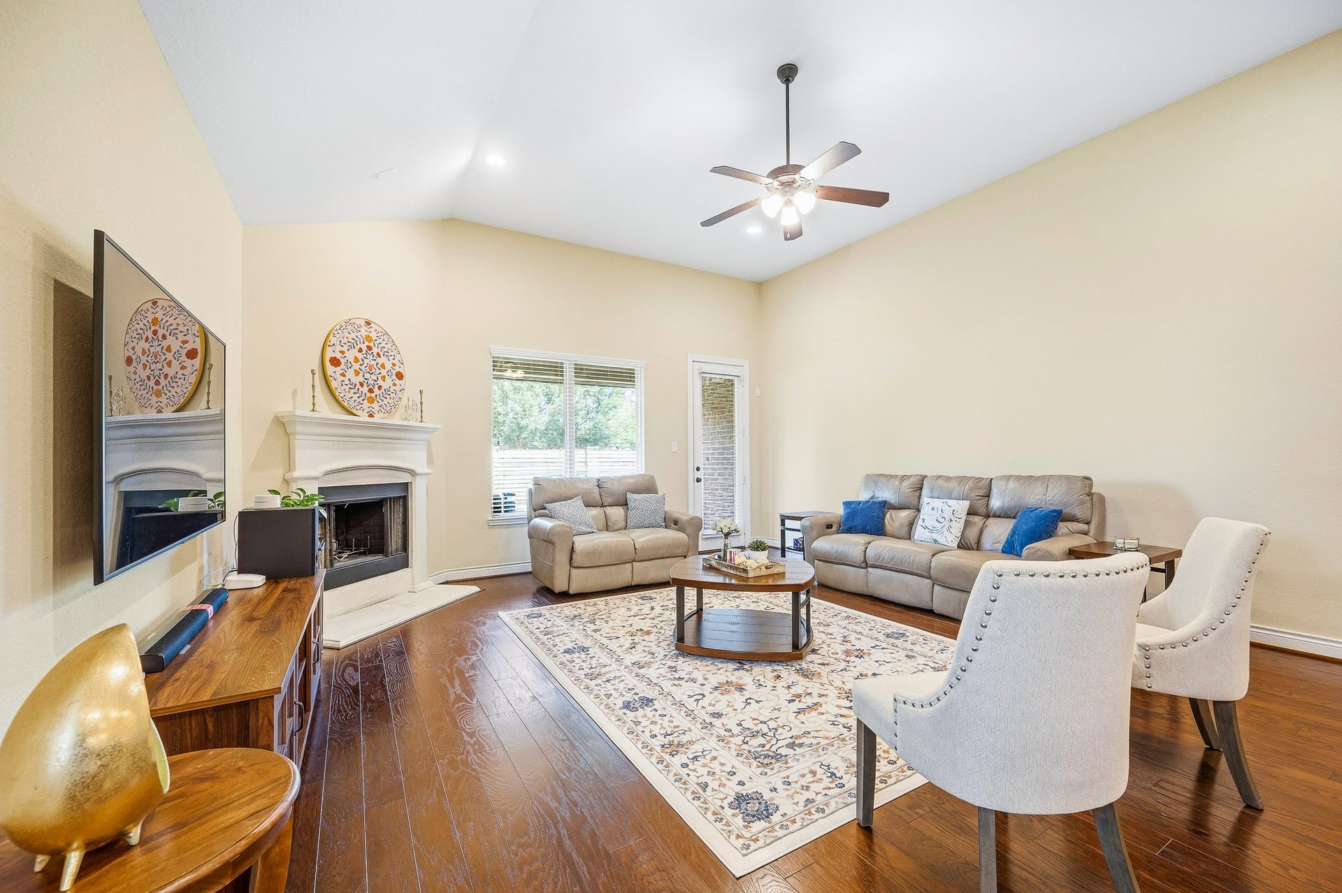 25610 Buckley Bluff Lane, Katy, TX 77494 Spacious living room combines relaxation and entertainment with high ceilings, a cozy fireplace, and elegant hardwood floors.