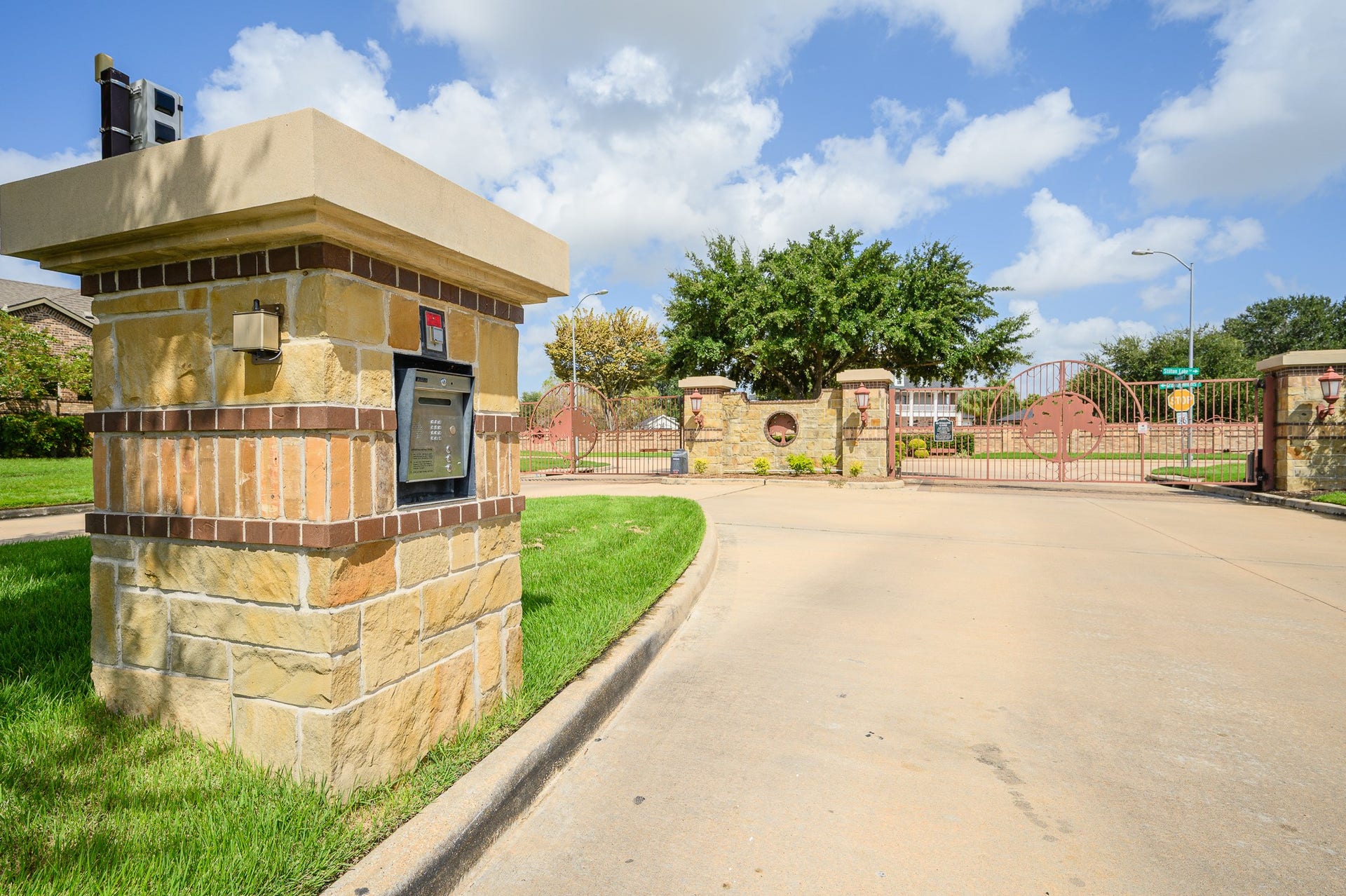 25610 Buckley Bluff Lane, Katy, TX 77494 Discover elegant privacy at this gated community entrance, featuring secure keypad access, lush landscaping, and stately stone pillars.