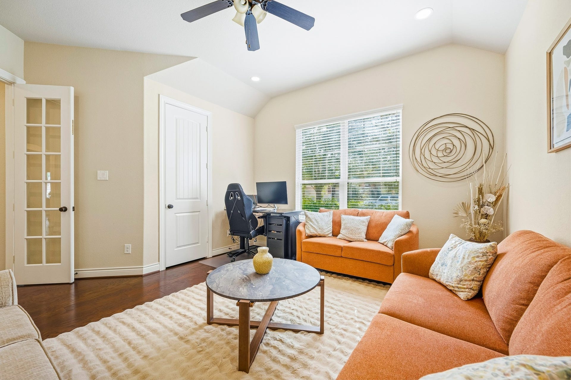 25610 Buckley Bluff Lane, Katy, TX 77494 Cozy and inviting, this living area features warm-toned seating, a central coffee table, and an abundance of natural light through large windows, perfect for relaxation or a chic home office.