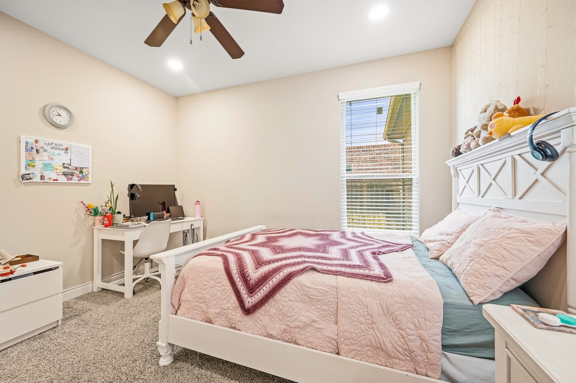 25610 Buckley Bluff Lane, Katy, TX 77494 Charming bedroom with soft neutral tones, a cozy bed, and a functional workspace under natural light from a large window.