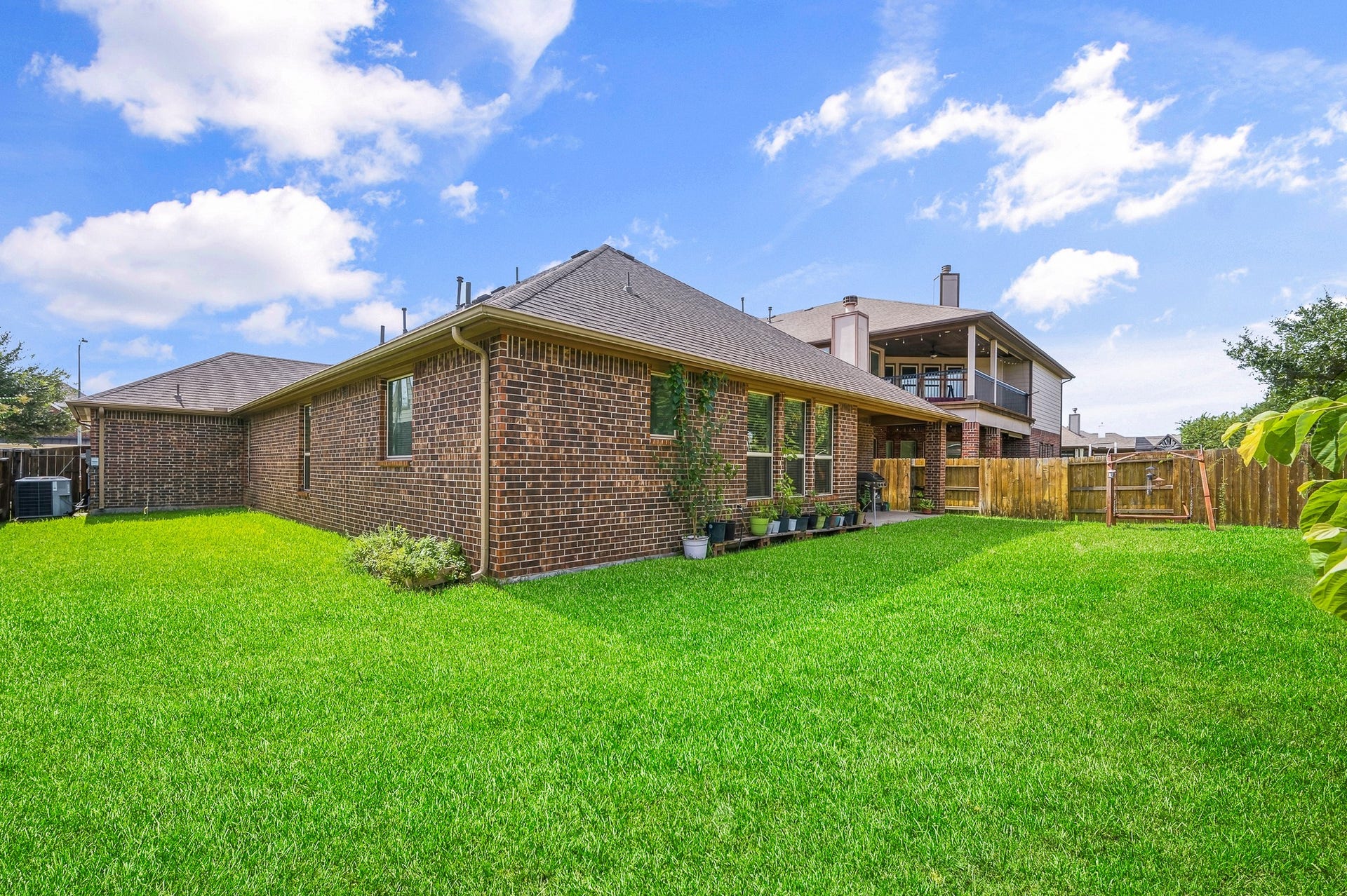 25610 Buckley Bluff Lane, Katy, TX 77494 Charming brick home featuring an expansive, lush backyard perfect for outdoor activities and gatherings.