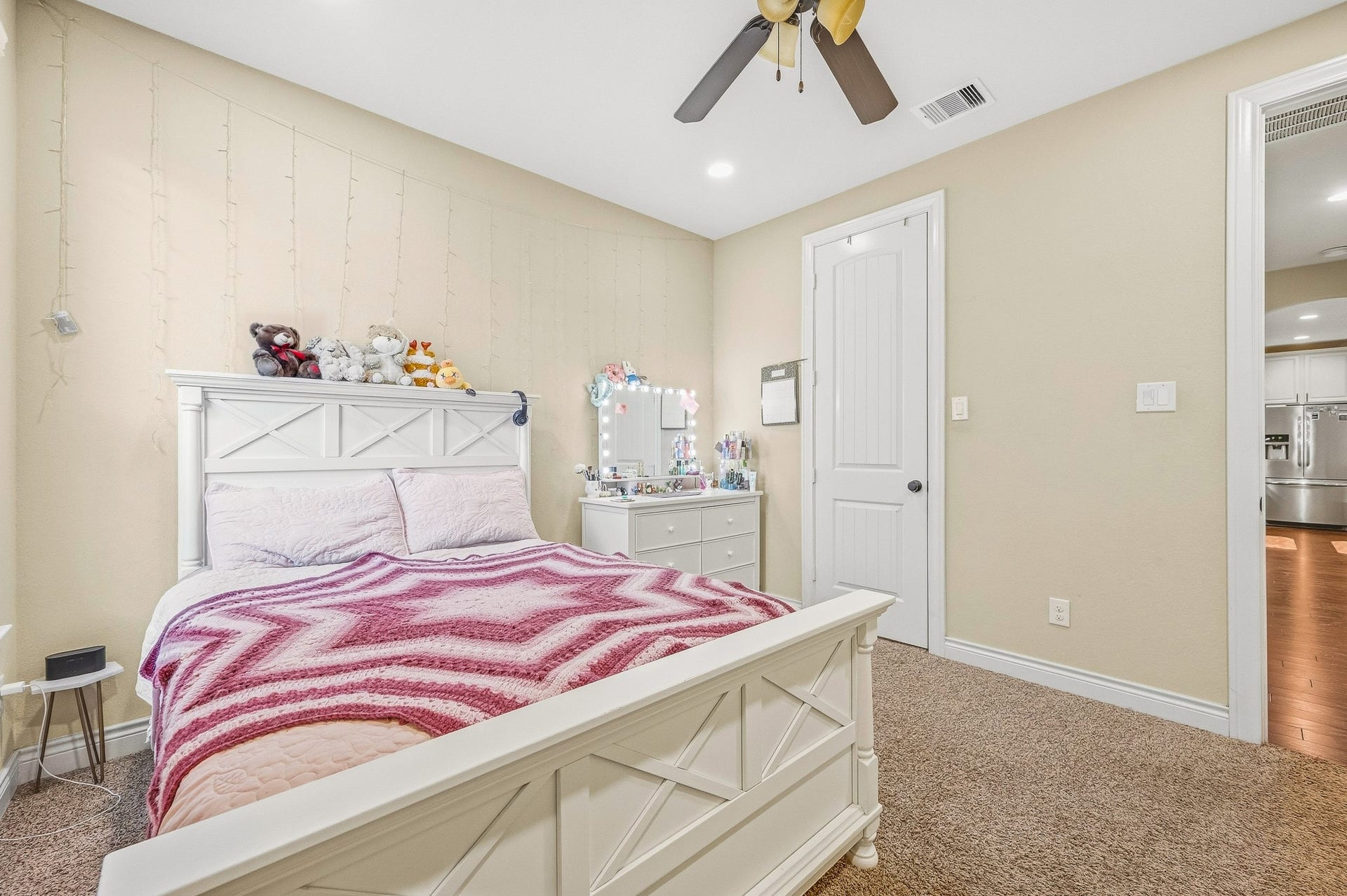 25610 Buckley Bluff Lane, Katy, TX 77494 A cozy bedroom featuring a white bedframe, plush carpeting, and soft lighting offers a warm, inviting atmosphere perfect for relaxation.