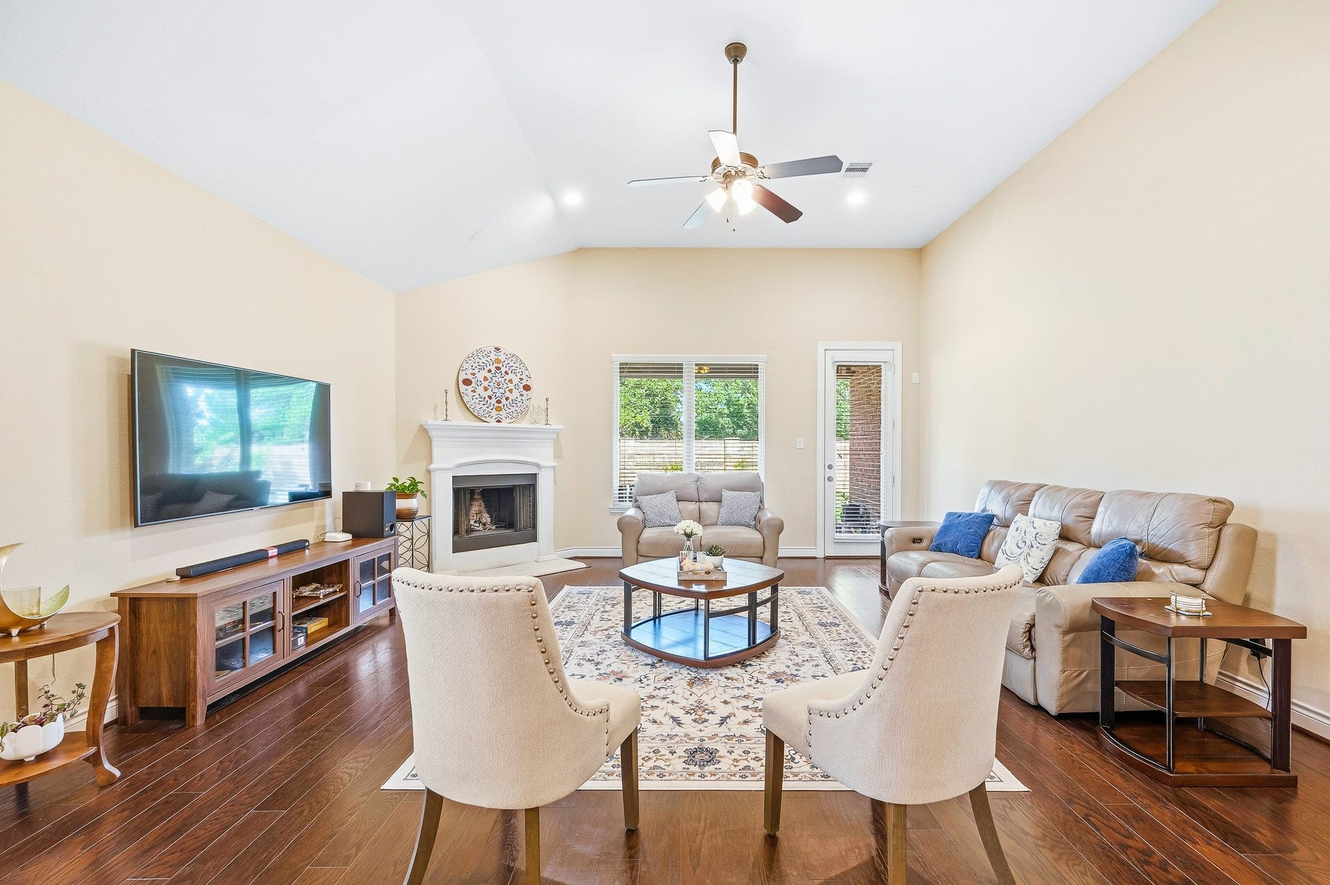 25610 Buckley Bluff Lane, Katy, TX 77494 Expansive living room with soaring ceilings, a welcoming fireplace, elegant seating, and large windows that flood the space with natural light.