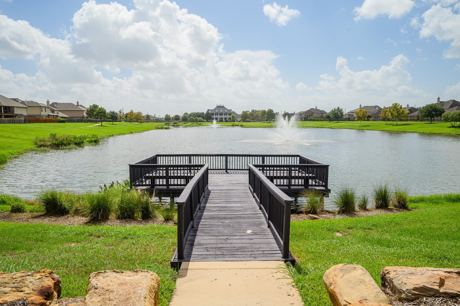 25610 Buckley Bluff Lane, Katy, TX 77494 Embrace tranquil waterfront living with serene lake views, a central fountain, private dock, and lush greenery, perfect for relaxation and connecting with nature.