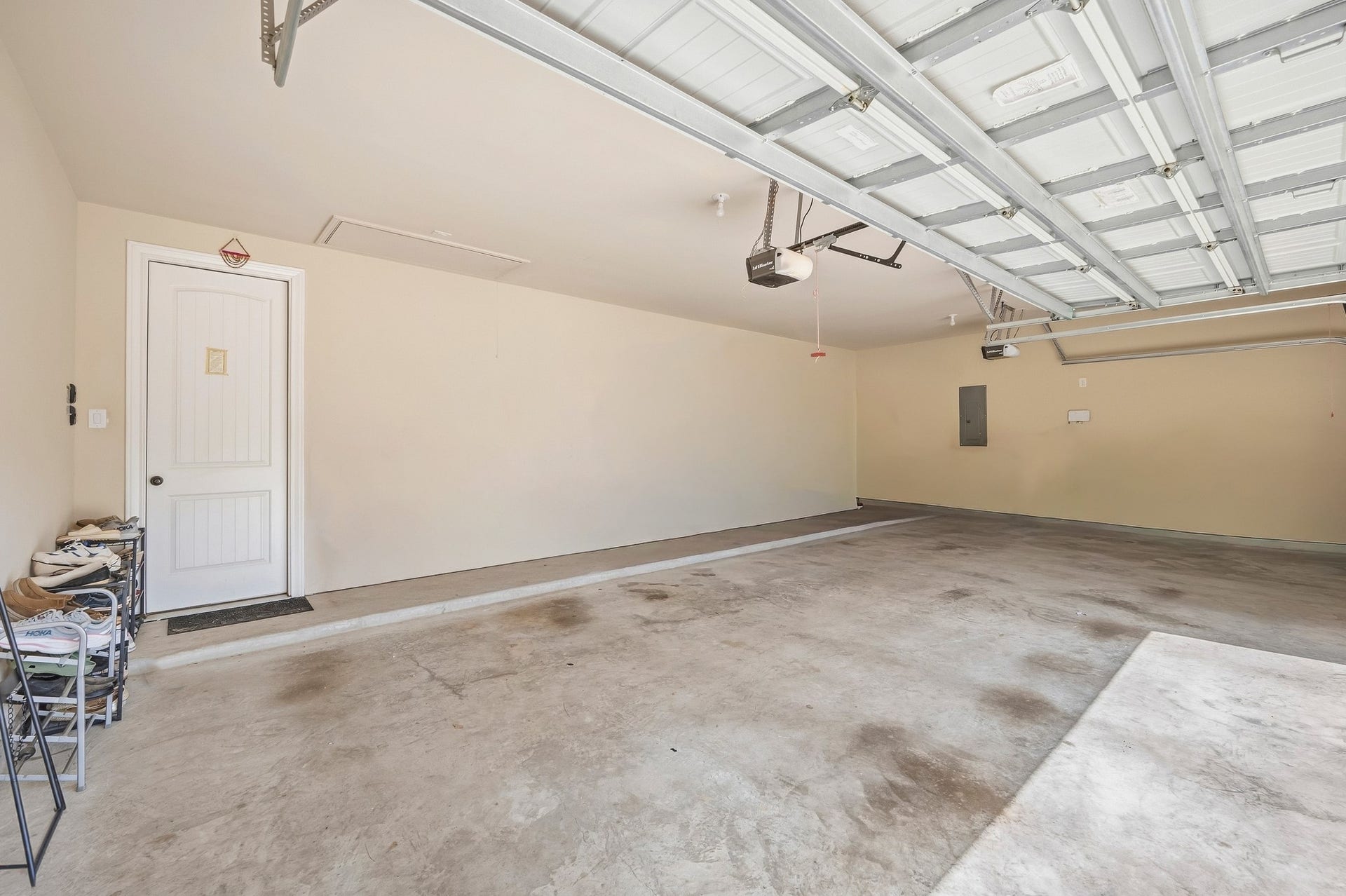 25610 Buckley Bluff Lane, Katy, TX 77494 Spacious three-car garage with ample floor space, overhead storage, and interior access through a side door, making it perfect for all your storage and parking needs.