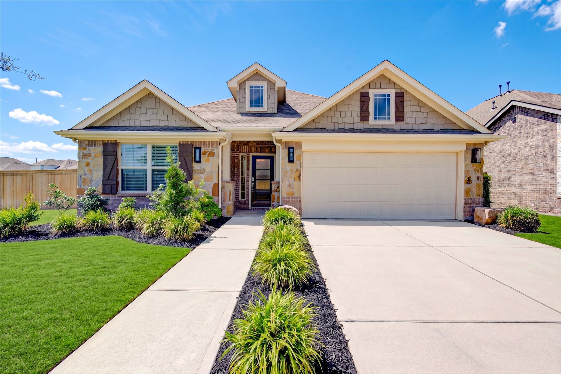 8803 Oak Springs Drive, Missouri City, TX 77459 Beautifully maintained single-story home with charming curb appeal, lush landscaping, and a spacious two-car garage.