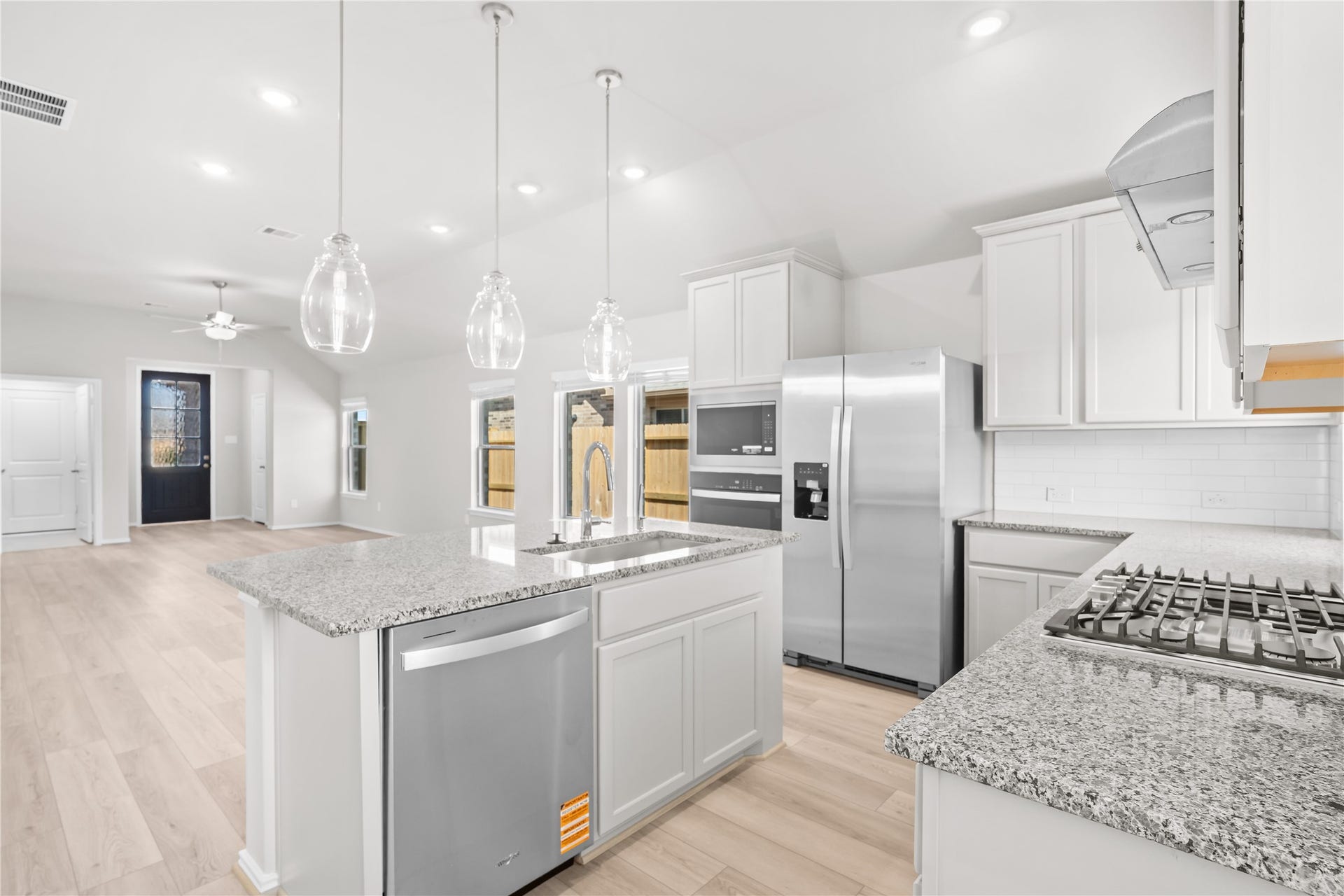 Stainless steel appliances include the refrigerator, dishwasher, built in microwave and gas cooktop, all overlooking the family room.