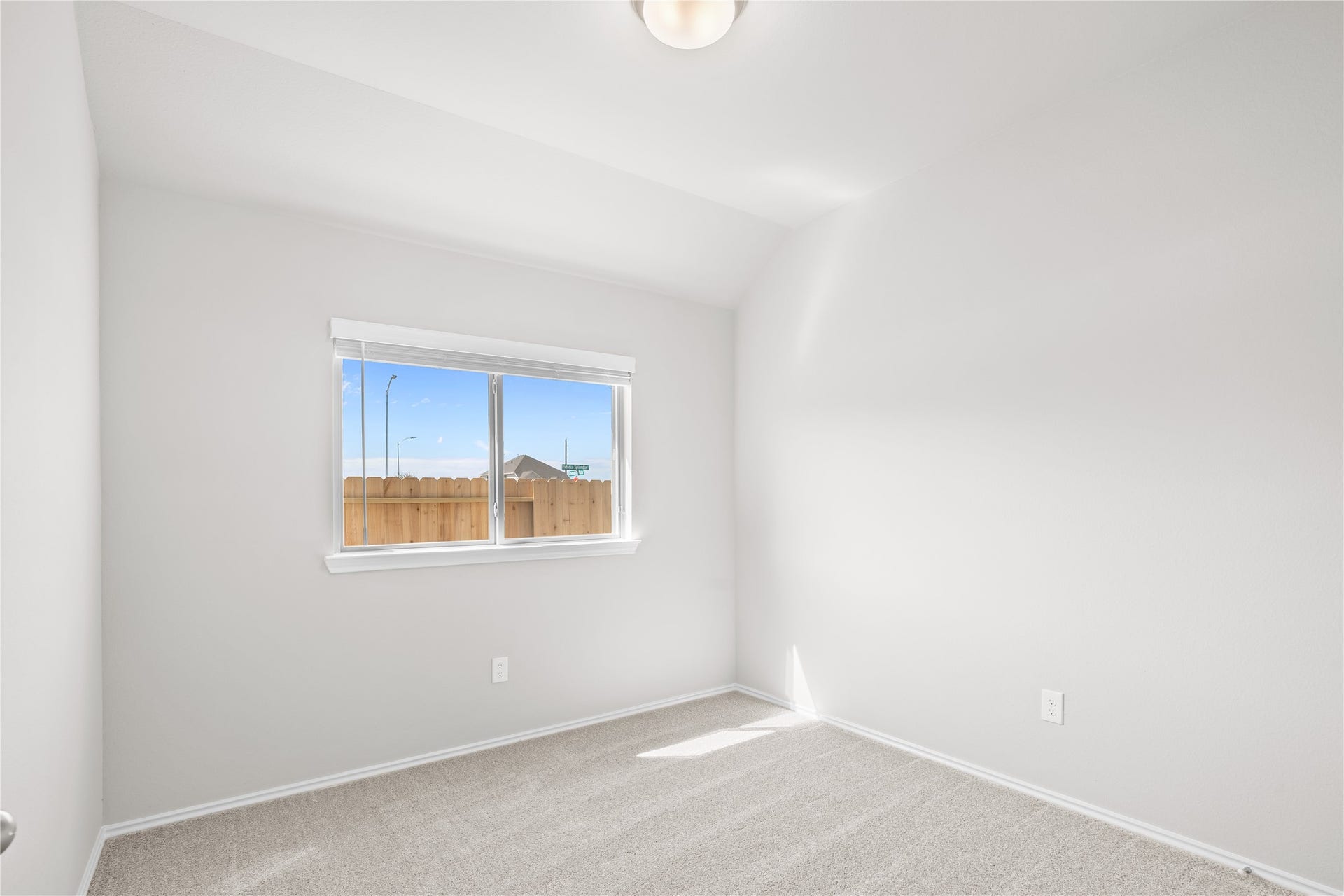 A large window brightens this secondary bedroom, ideal as a guest room or home office.