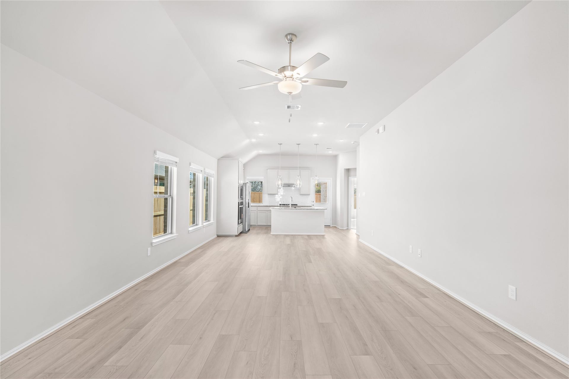 A straight on view highlights the family room's generous proportions and clear sightlines to the kitchen, ideal for everyday living and entertaining.