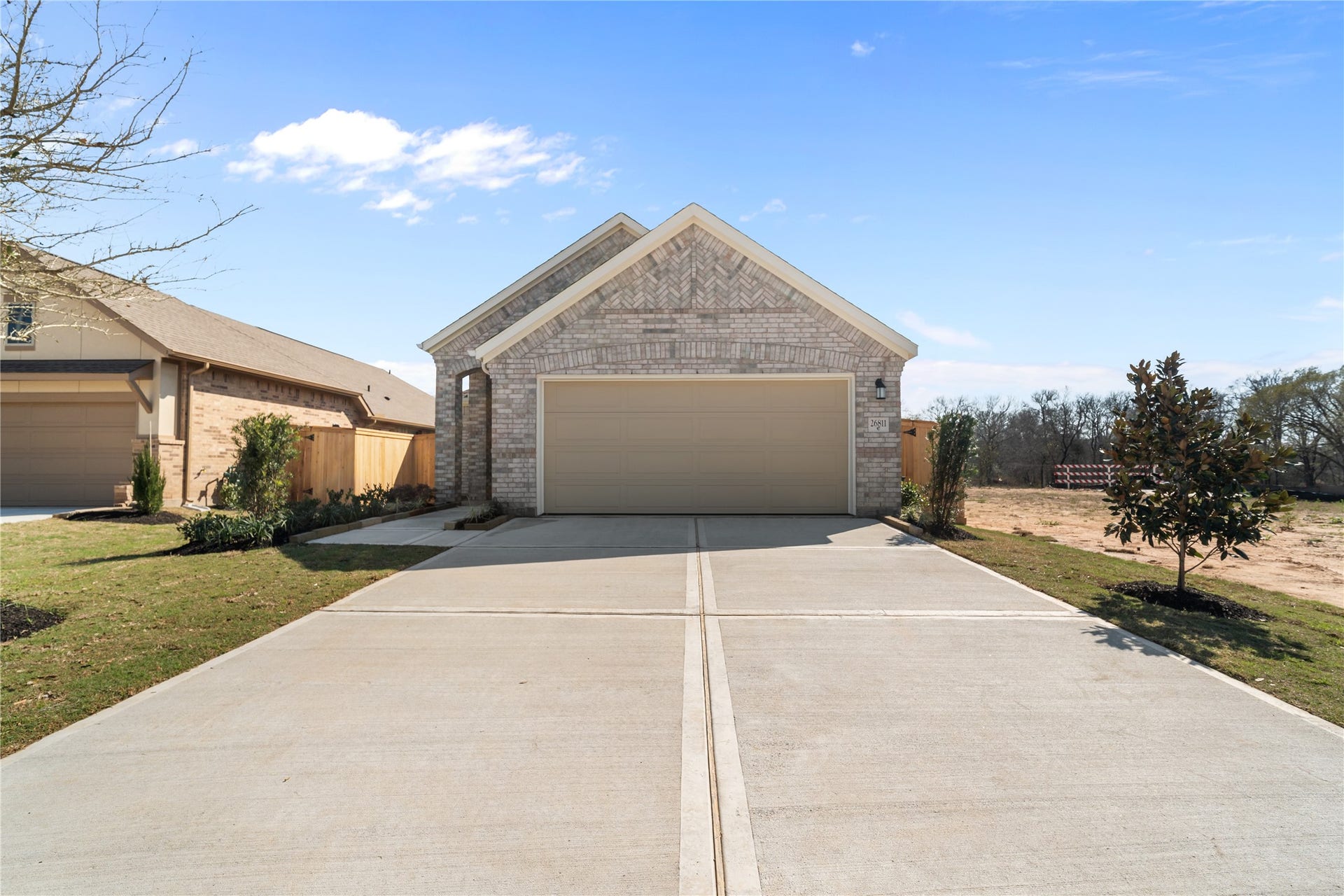 Welcome to 114 Mercury Sky Road, where a brick exterior, attached two-car garage and wide concrete driveway set the tone.
