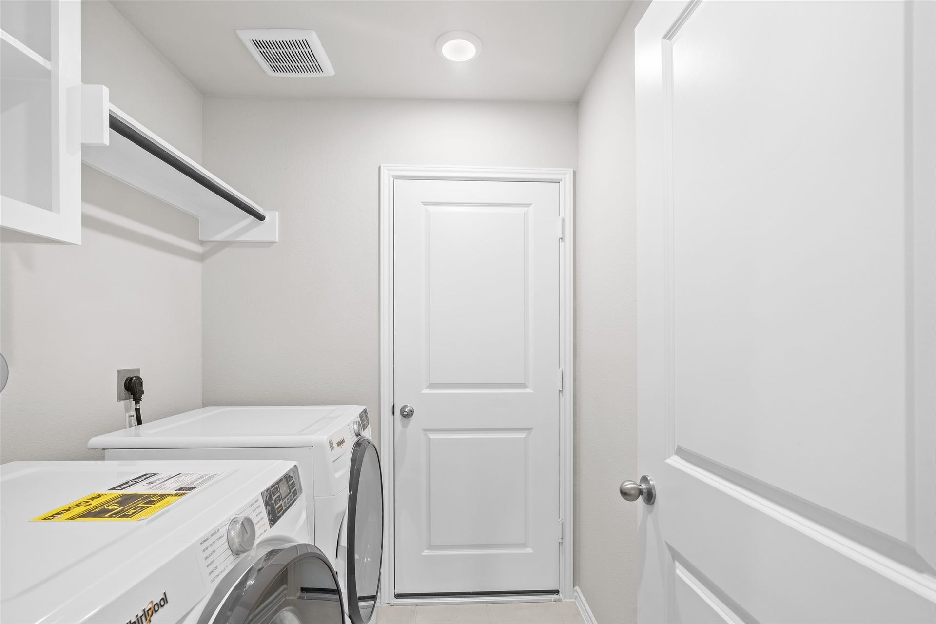 The utility room comes with a washer and dryer included, plus upper shelving.