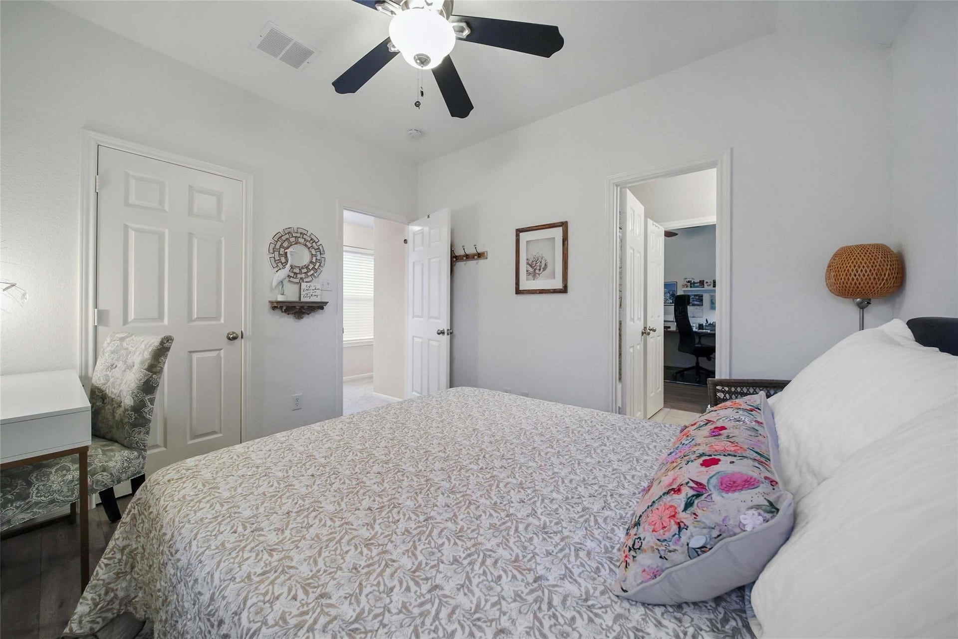 spacious Primary walk-in closet with organized shelving and hanging space for a variety of clothing and accessories, featuring tiled flooring and good lighting.