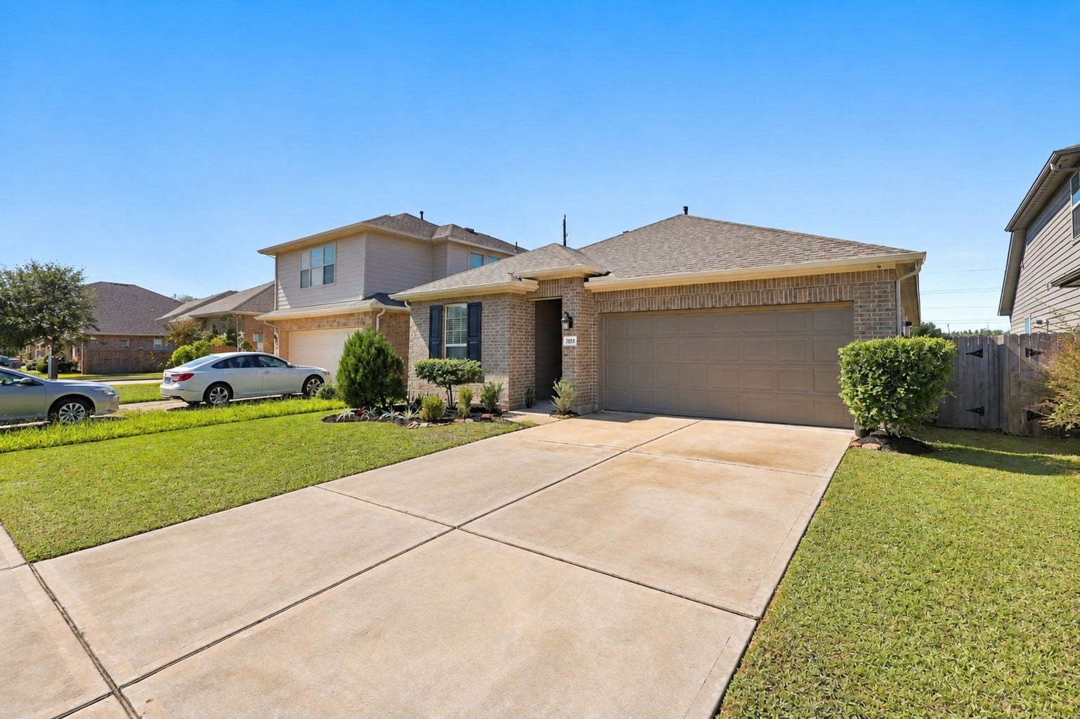 7814 Tindarey Maple Trace, Richmond, TX 77407 Attractive brick exterior, mature shade tree, and spacious driveway along a cul-de-sac street.