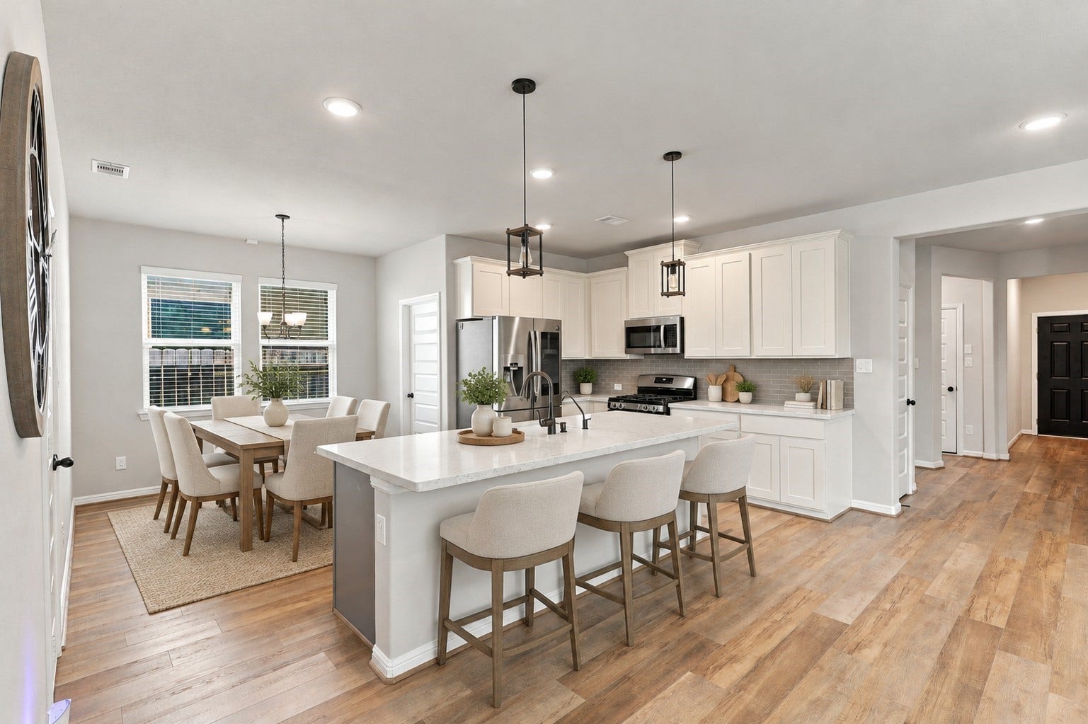 7814 Tindarey Maple Trace, Richmond, TX 77407 Spacious kitchen with an oversized island, stainless steel appliances, and sleek subway-tile backsplash.**Virtually staged