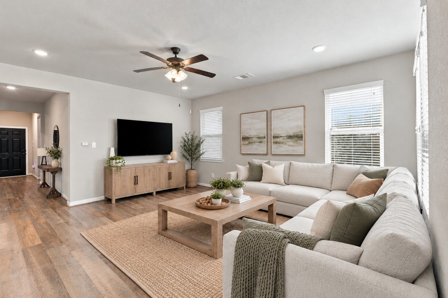 7814 Tindarey Maple Trace, Richmond, TX 77407 Spacious family room with a clear view of the entry hallway and easy access to the home's adjoining spaces.**Virtually staged