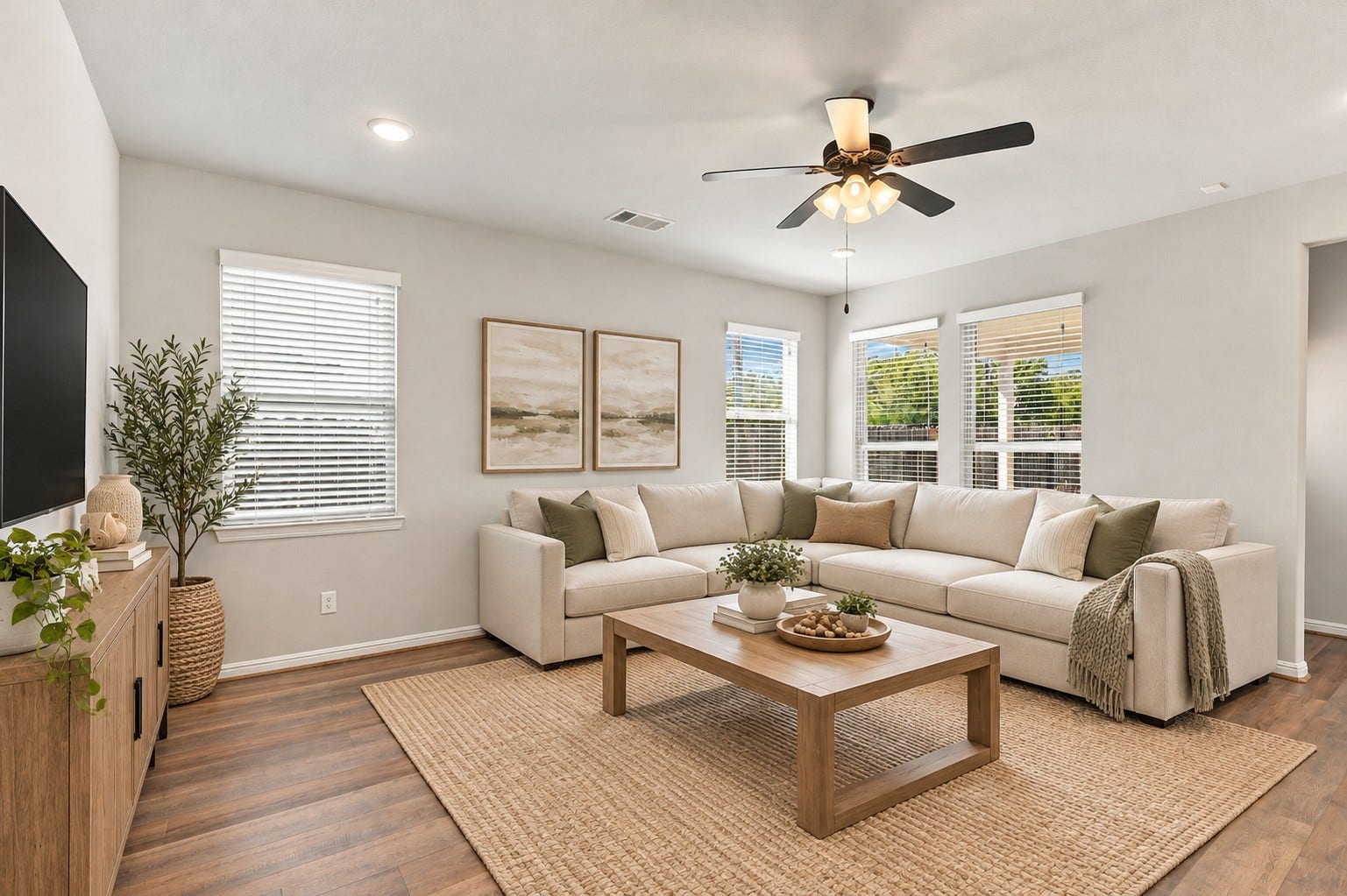 7814 Tindarey Maple Trace, Richmond, TX 77407 Spacious, naturally lit family room with multiple windows, a ceiling fan, and an open layout ideal for everyday living.**Virtually staged