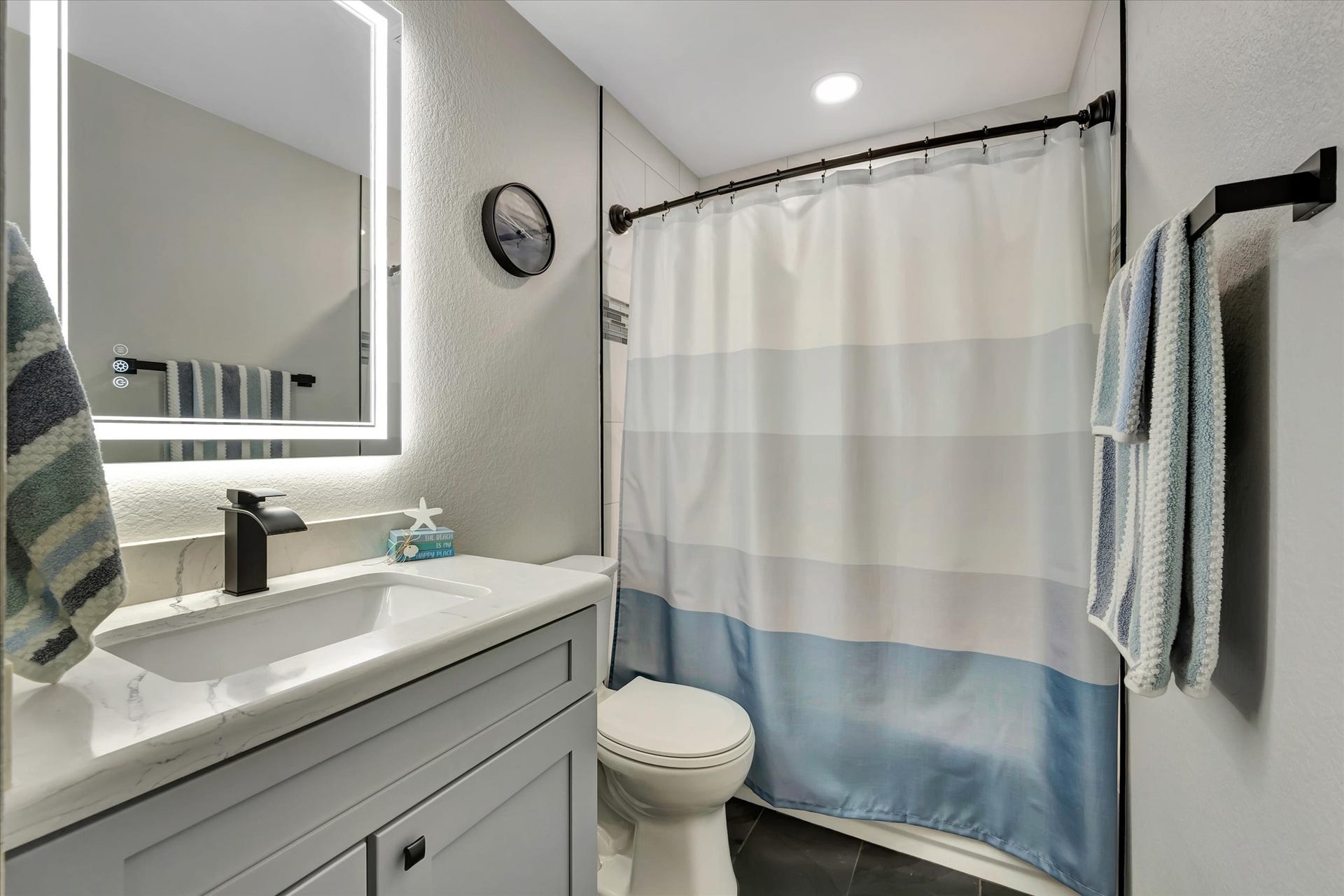 4802 Quiet Canyon Drive, Friendswood, TX 77546 The hall bathroom has also been exquisitely redone with modern fixtures and lighting.