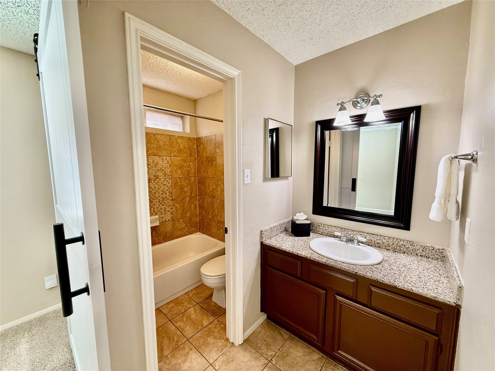 6 Leverwood Court, The Woodlands, TX 77381 Primary bathroom vanity with generous counter space and a framed mirror.