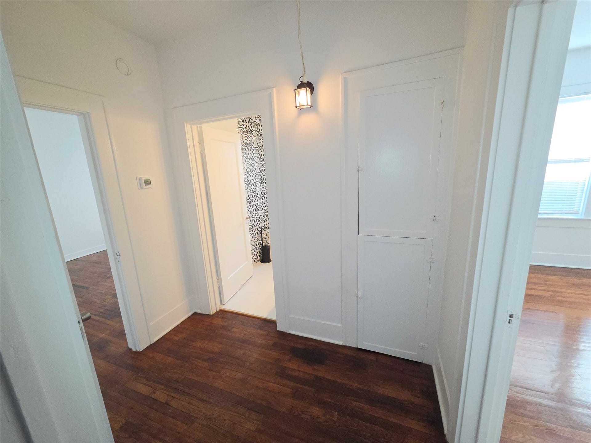 1449 Munger Street, Houston, TX 77023 hallway with entrance to guest bath and both guest bedrooms