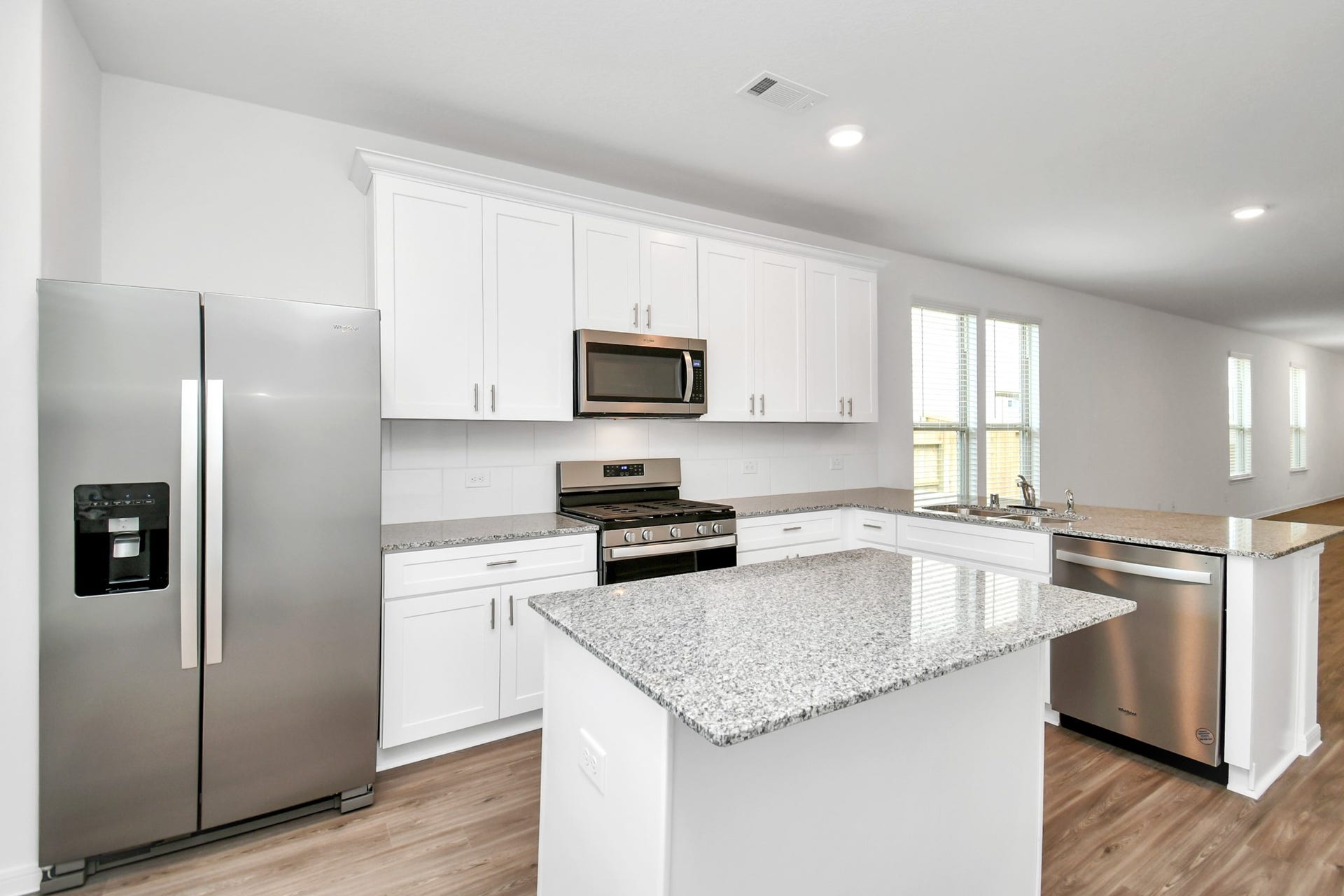 16150 Elbridge Court, Conroe, TX 77302 Kitchen fully equipped with stainless steel appliances including side-by-side refrigerator.