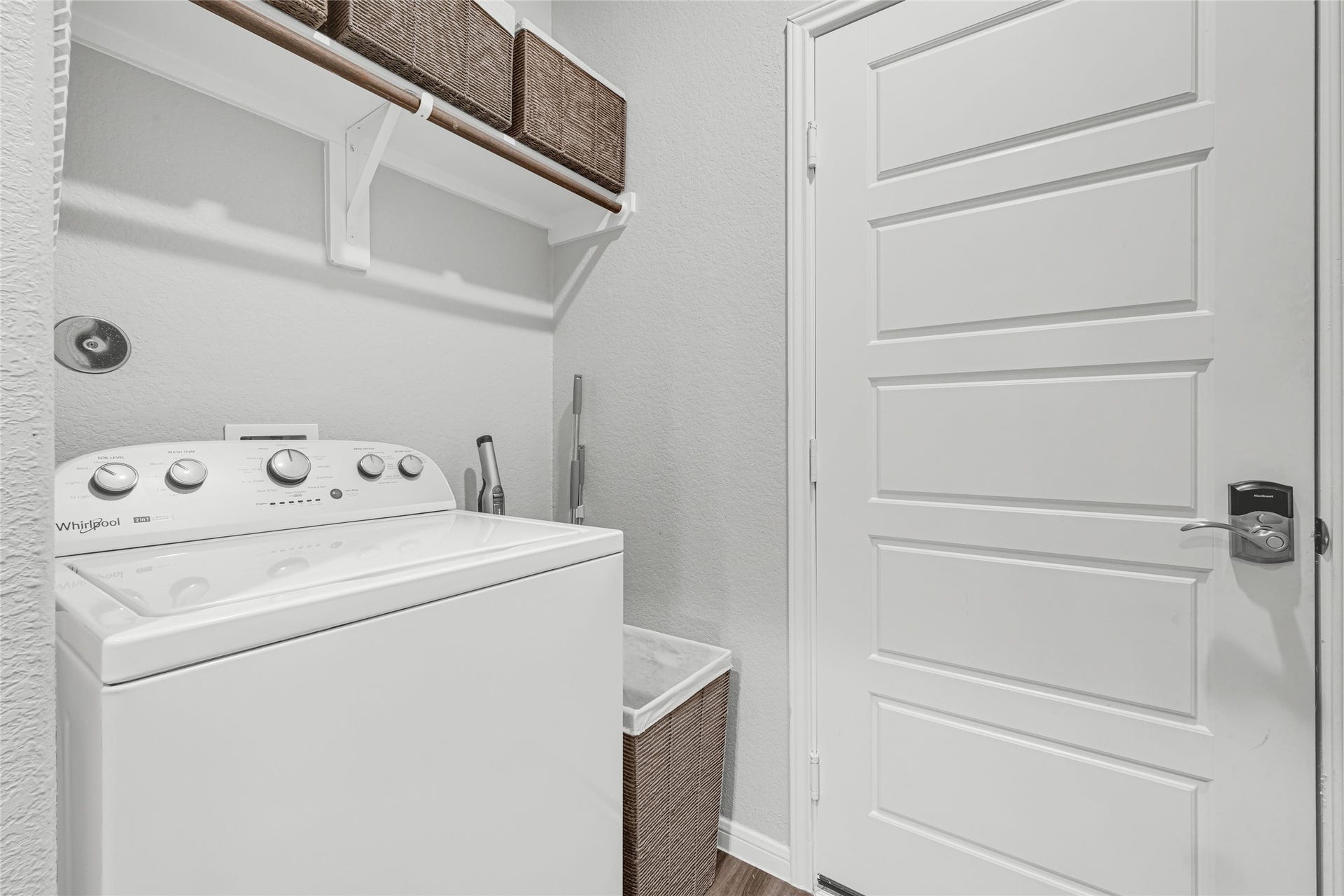 515 Emerald Thicket Lane, Houston, TX 77336 Discover a functional and tidy laundry room with a hanging rod, overhead storage, and ample space for essentials, perfect for streamlined household chores.