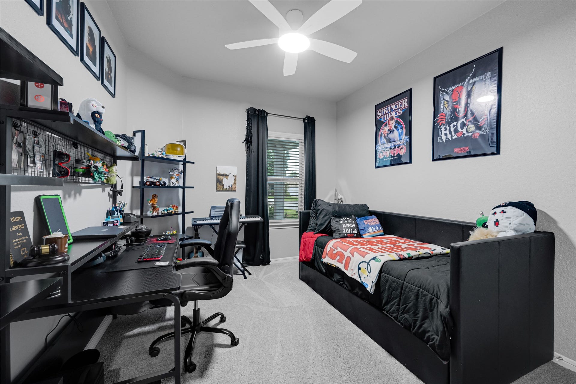 515 Emerald Thicket Lane, Houston, TX 77336 This cozy bedroom features a modern feel. The room is brightened by a ceiling fan and a window with 2 inch faux wood blinds, creating a stylish and functional space.