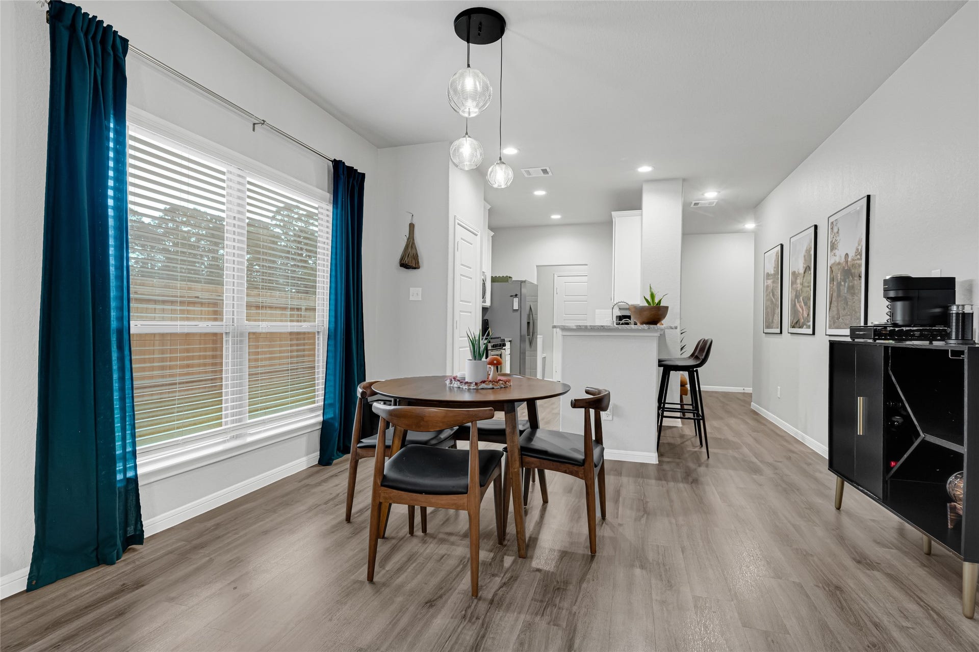 515 Emerald Thicket Lane, Houston, TX 77336 Discover a bright, inviting dining area framed by expansive windows that fill the space with natural light. The open-concept design offers flexibility for everyday living and entertaining, while upgraded designer pendant lighting adds a polished, modern touch.