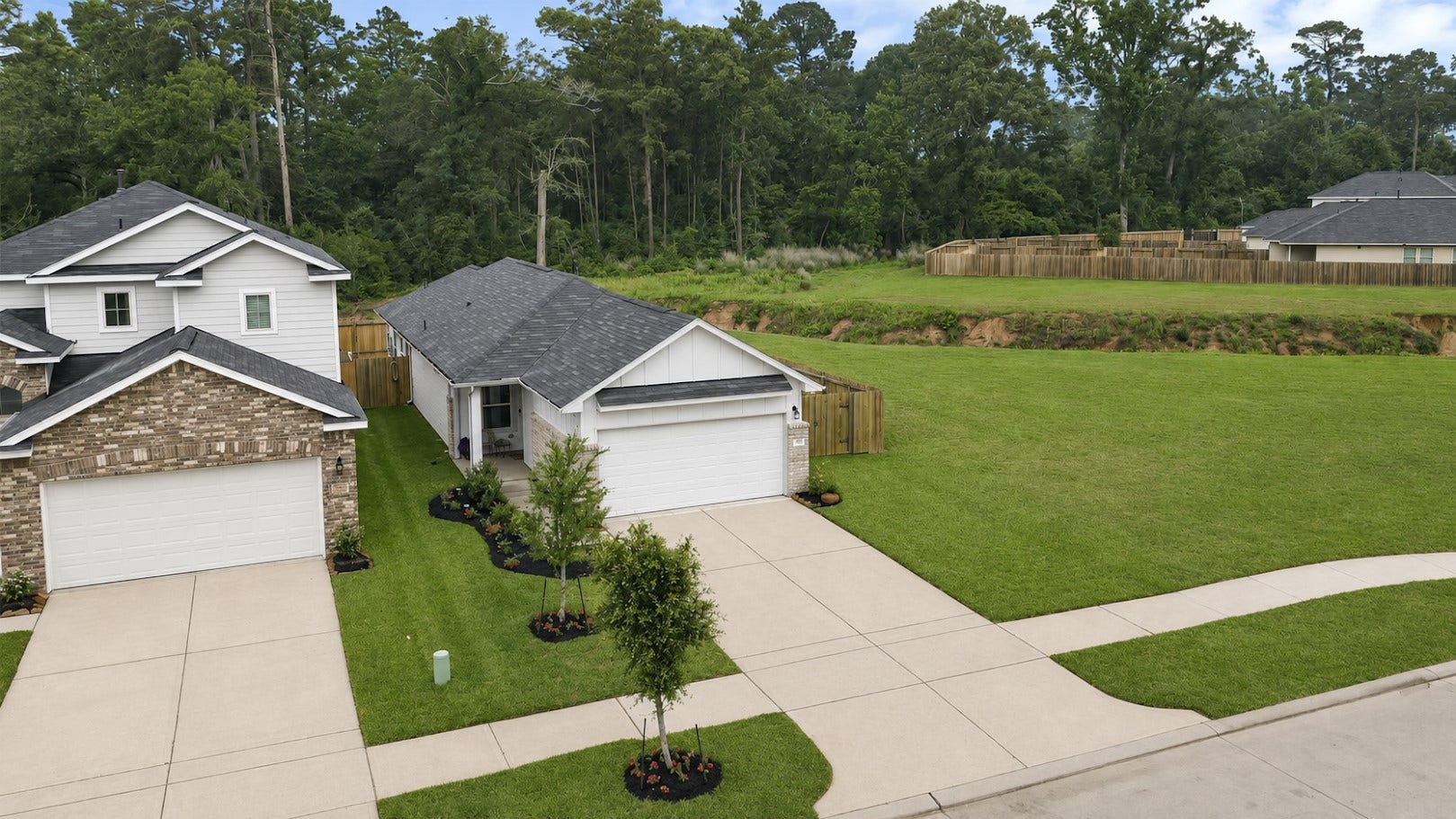 515 Emerald Thicket Lane, Houston, TX 77336 Charming single-story home has gutters installed in the front and a wooded backdrop, providing a peaceful setting.