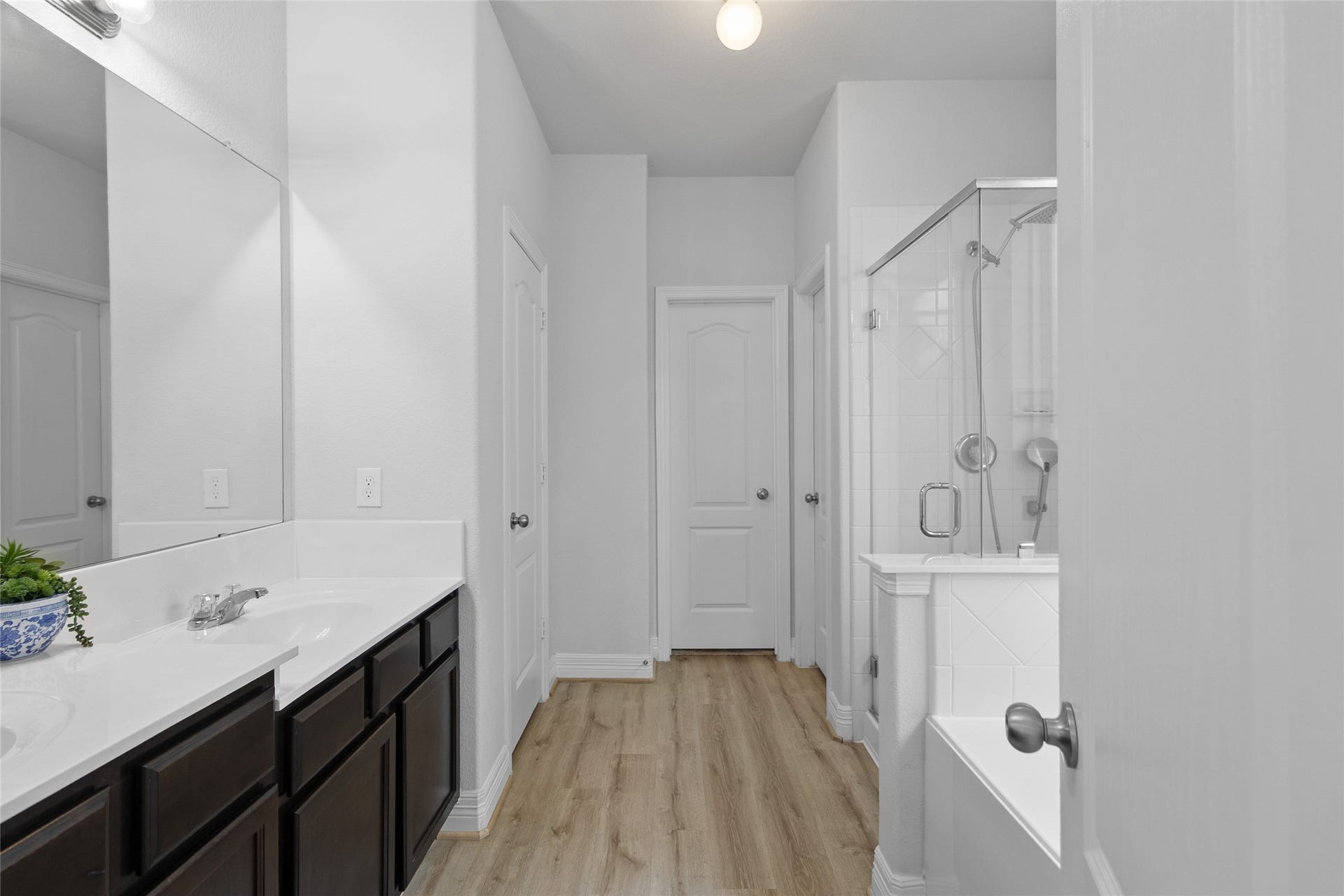 Your bathroom keeps the morning routine organized with a long vanity, generous counter space, and plenty of cabinetry.