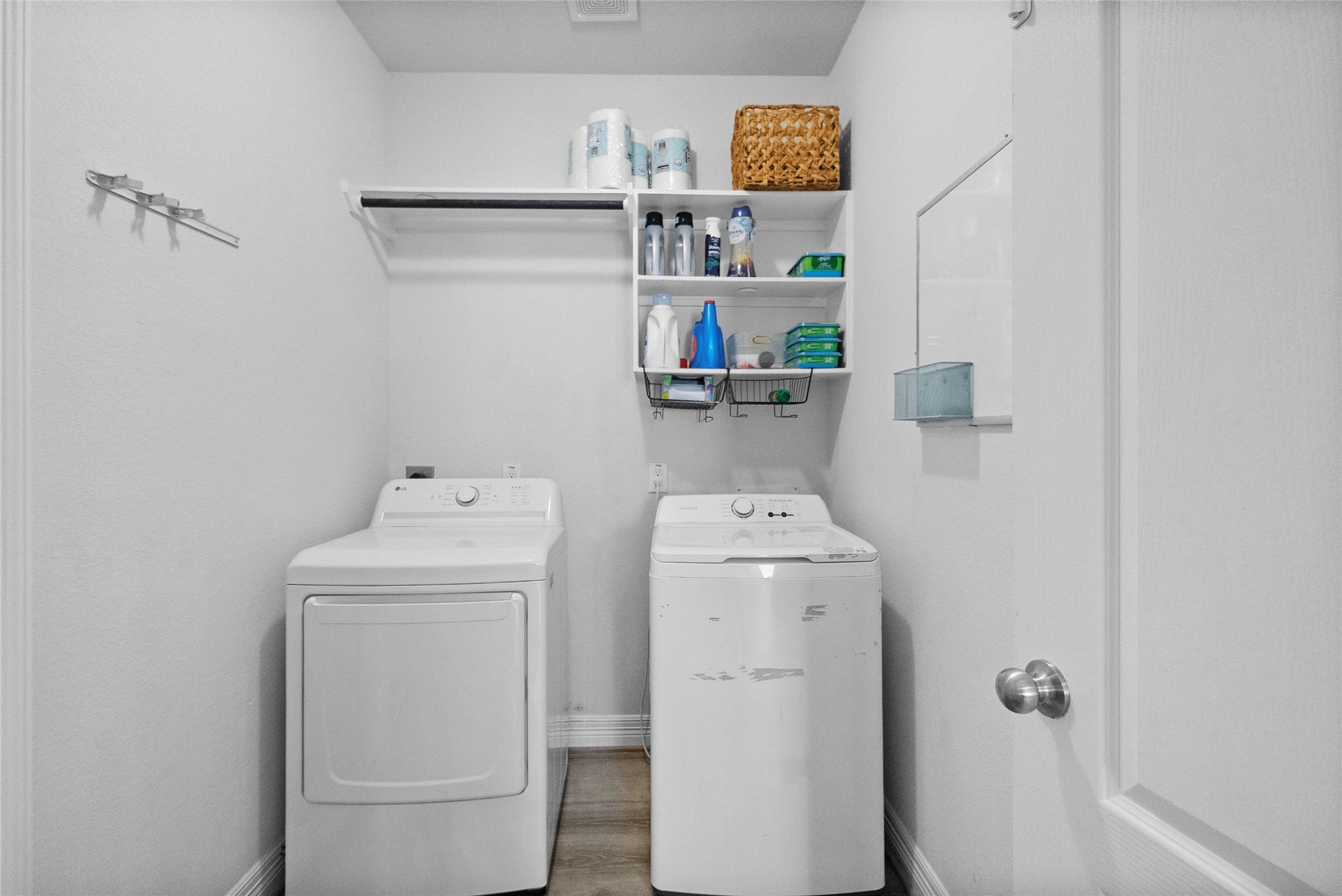 Laundry stays simple with your washer and dryer tucked into a dedicated space with shelving for everyday essentials.