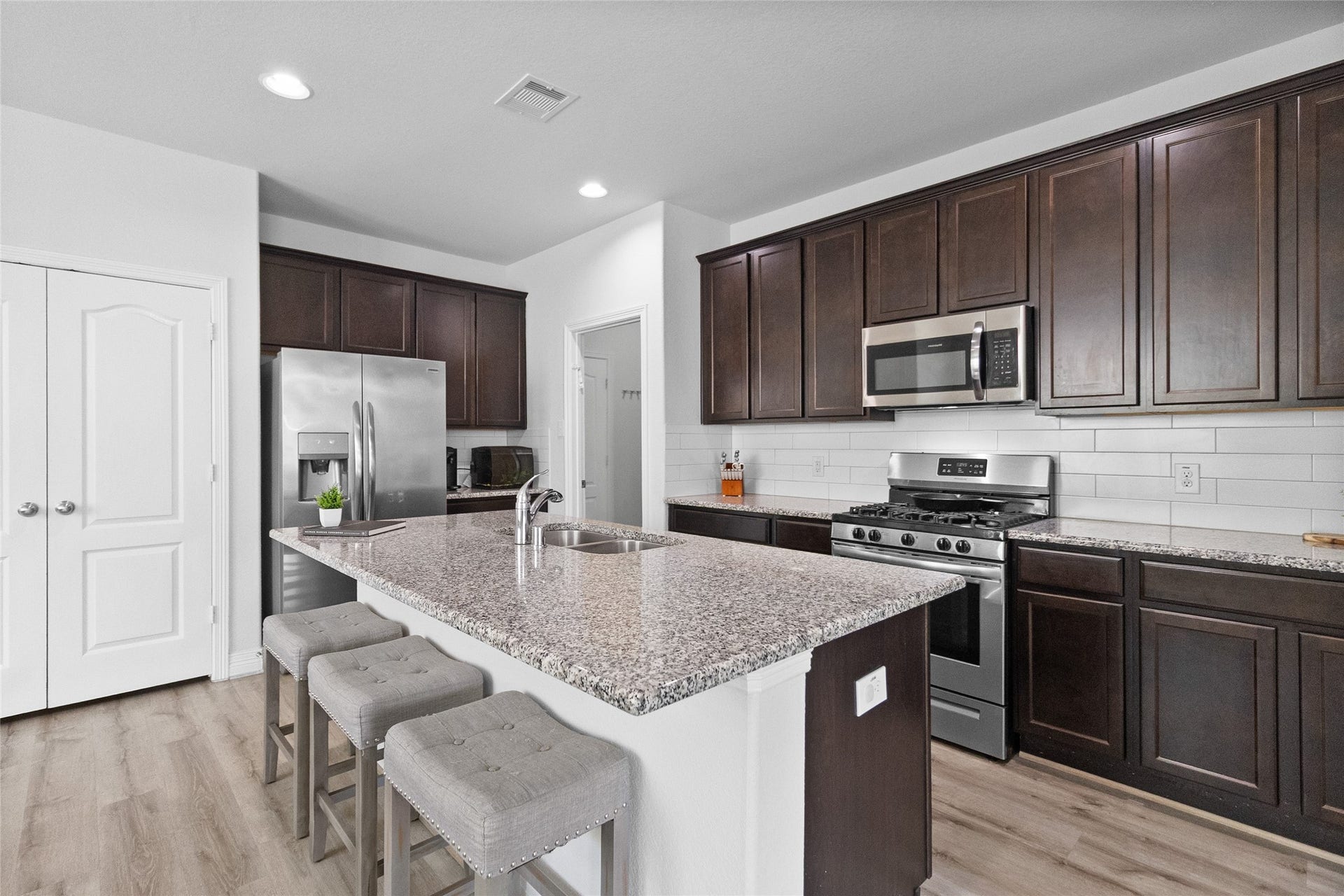 Cooking stays social in your open kitchen, where the island provides extra prep space and casual seating for everyday meals.