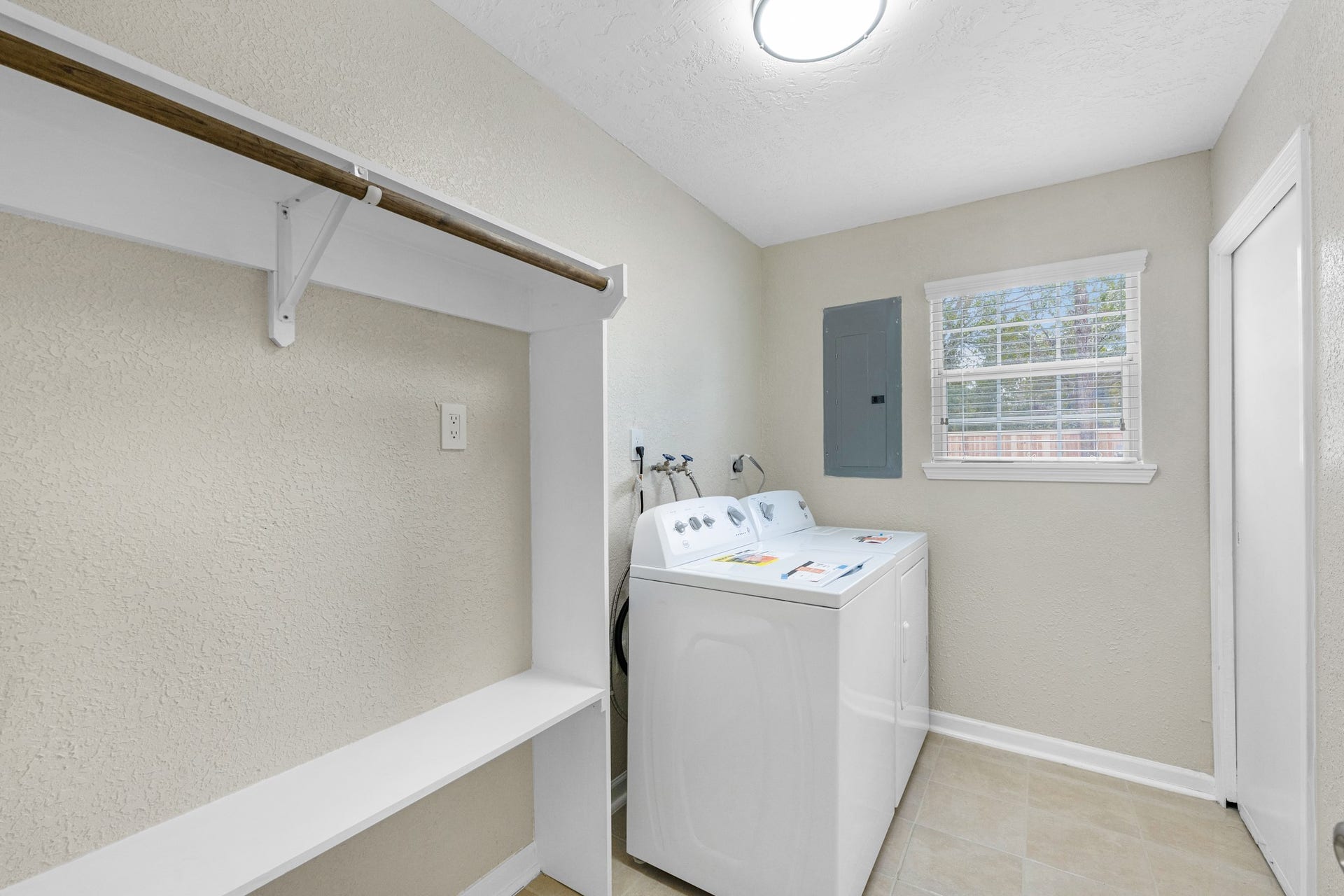 17435 Wells Drive, #CR115, Pearland, TX 77584 Before heading outside, the laundry room includes a built-in bench and hanging rod.