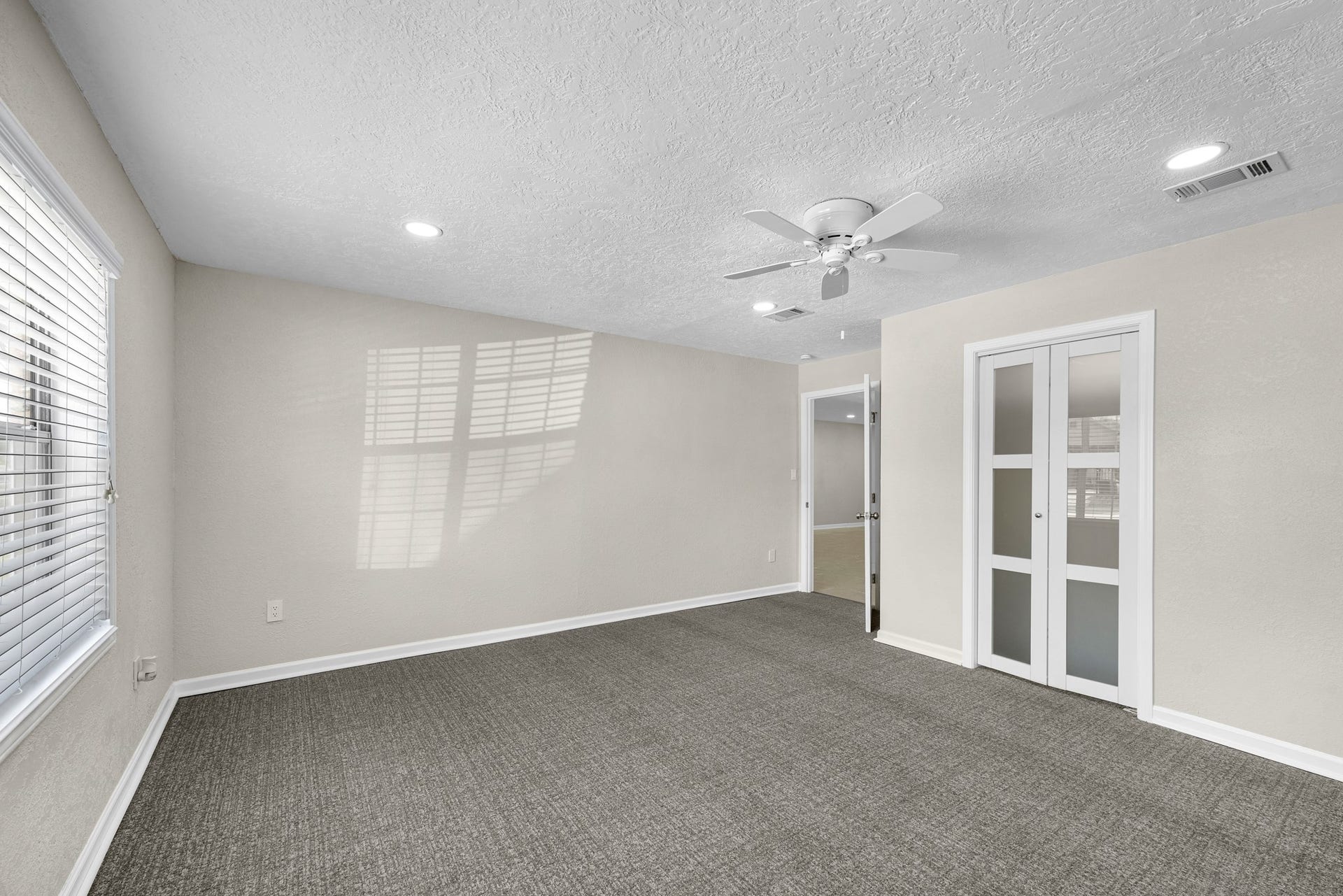 17435 Wells Drive, #CR115, Pearland, TX 77584 This bedroom also includes a closet with frosted glass doors.