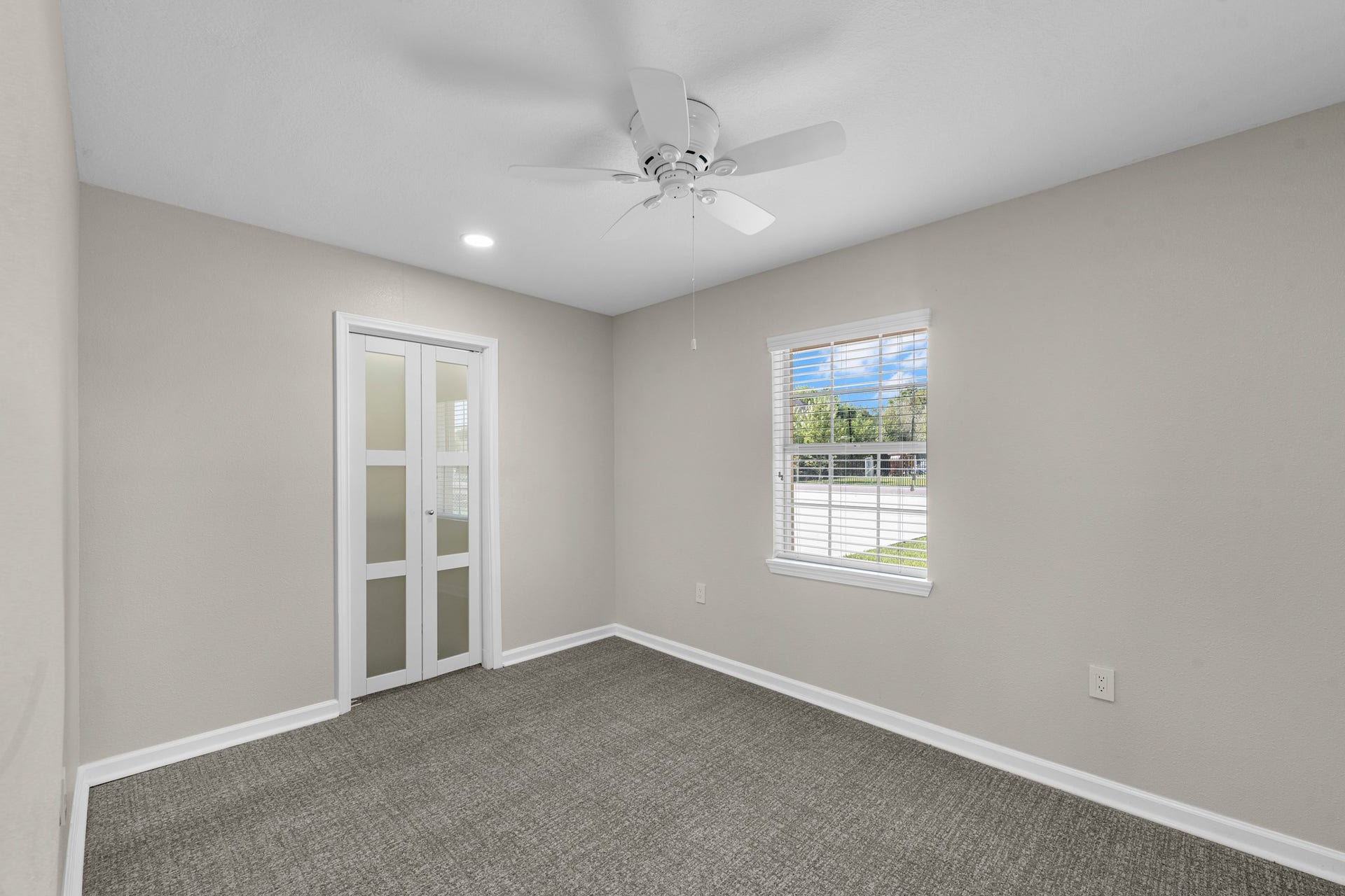 17435 Wells Drive, #CR115, Pearland, TX 77584 The next bedroom offers a closet with frosted glass doors and a window for natural light.