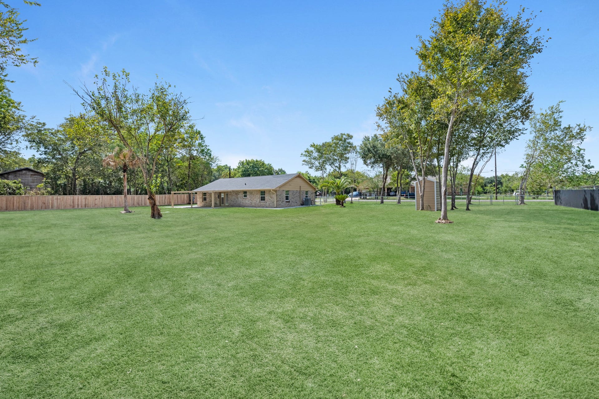17435 Wells Drive, #CR115, Pearland, TX 77584 Looking back toward the home, the backyard offers wide open space.