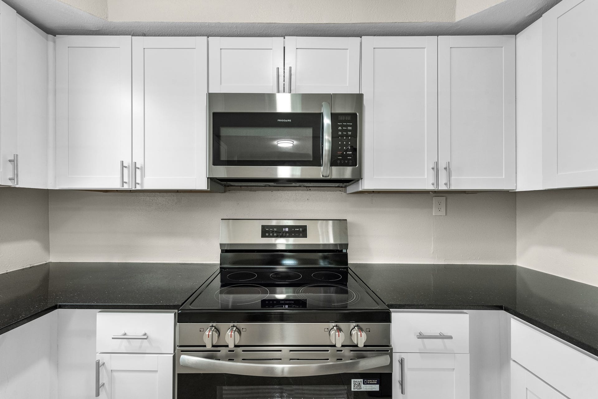 17435 Wells Drive, #CR115, Pearland, TX 77584 A sneak peek inside reveals the updated kitchen with dark granite countertops and SS appliances.