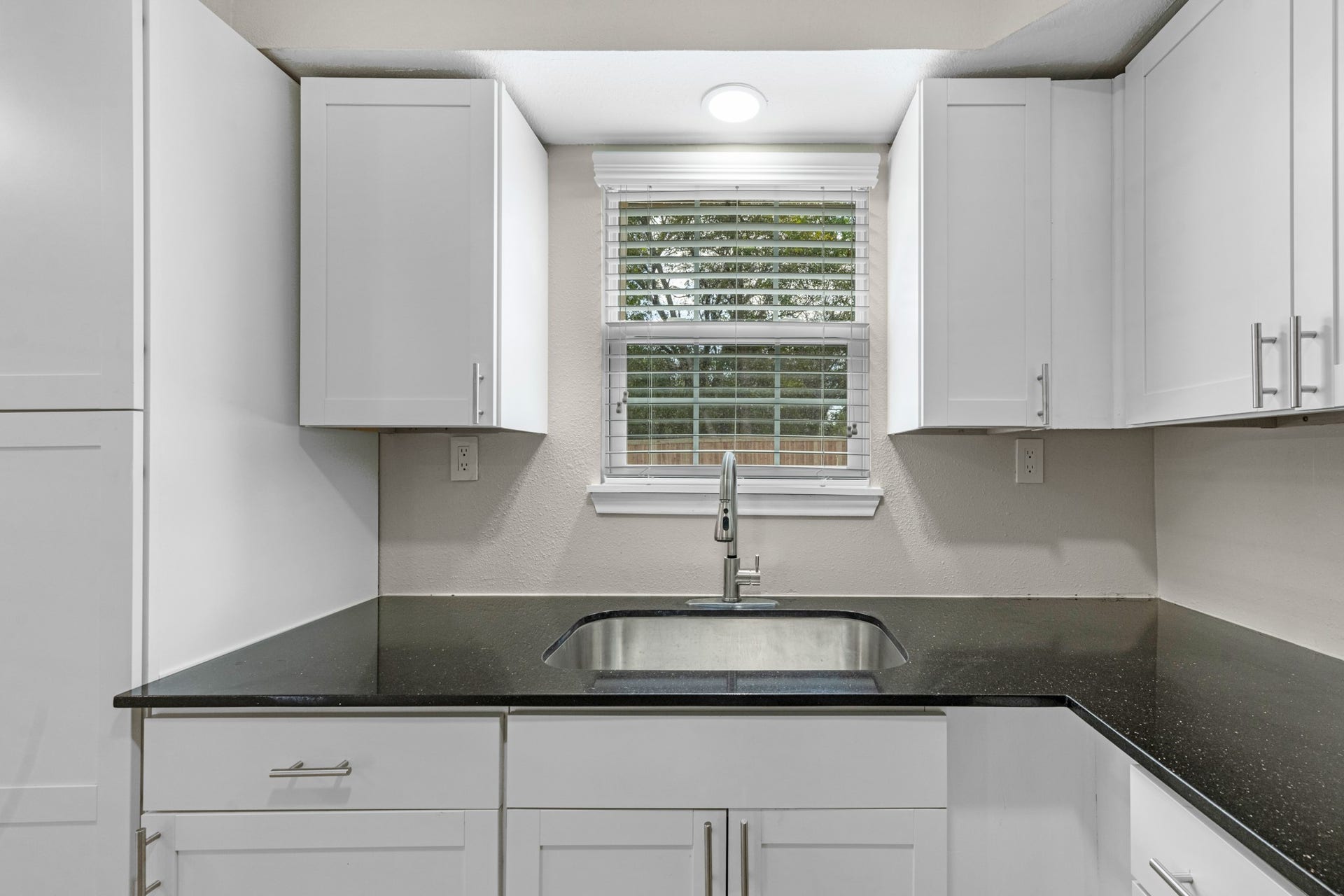 17435 Wells Drive, #CR115, Pearland, TX 77584 At the sink, a window brings in natural light, with ample cabinetry for storage.