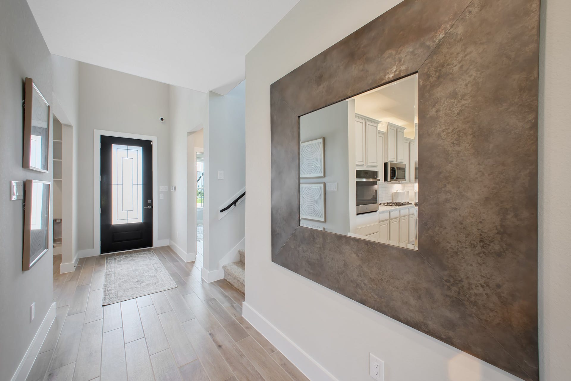 22122 Cortona Creek Lane, Hockley, TX 77447 As you step into the threshold of this luxurious home, you'll soon be welcomed by an elegant glass door. Inside, soaring ceilings amplify the spaciousness, while the refined wood-look tile flooring and oversized baseboards exude sophistication and charm.